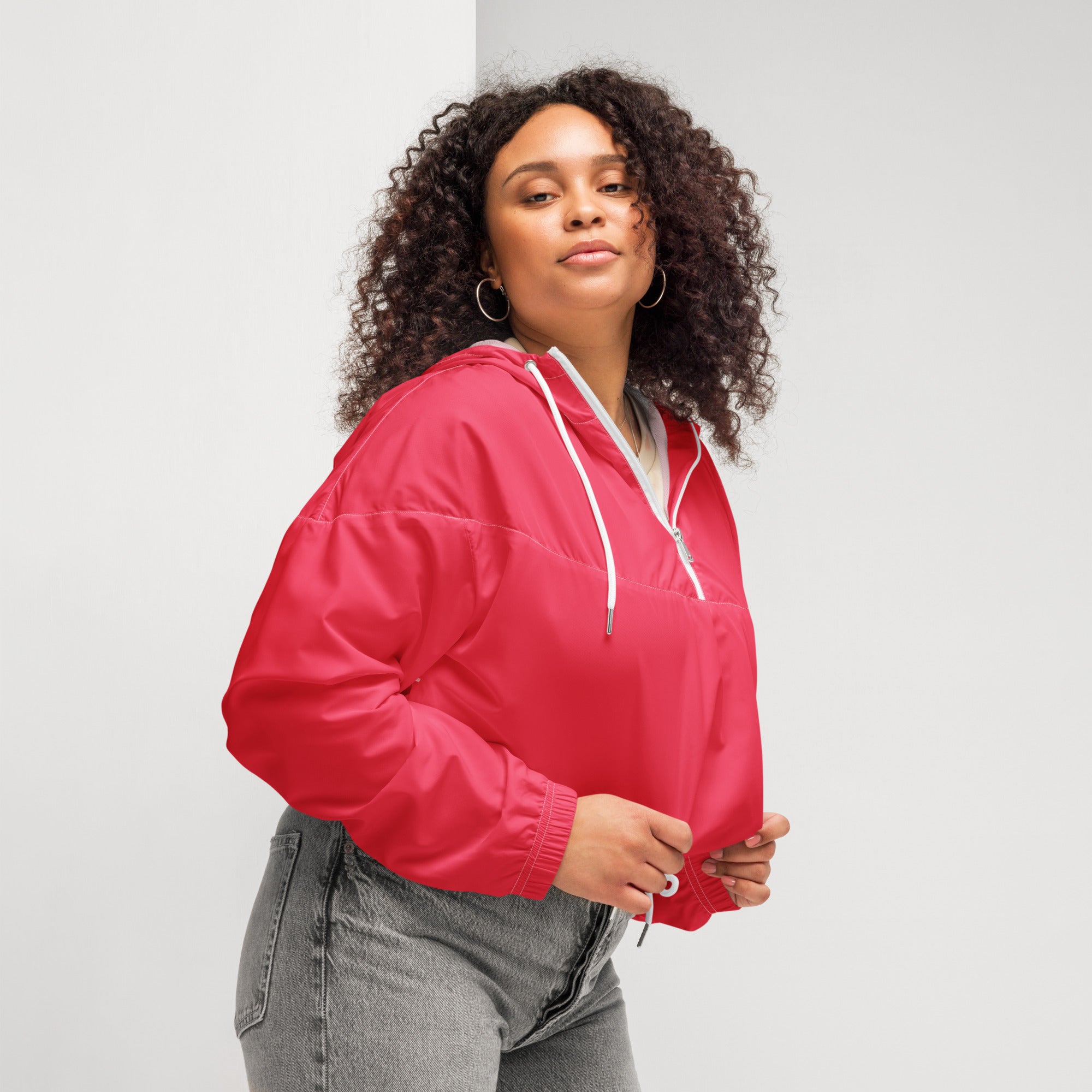 Women’s bright pink cropped windbreaker featuring a vibrant red puffer-style hooded jacket with white drawstrings and zipper accents