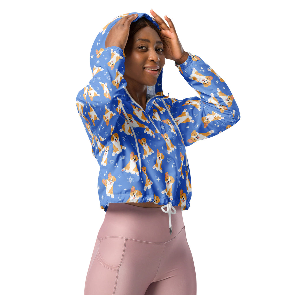 Women’s blue cropped windbreaker with adjustable hood features lightweight water resistant fabric and a corgi dog pattern