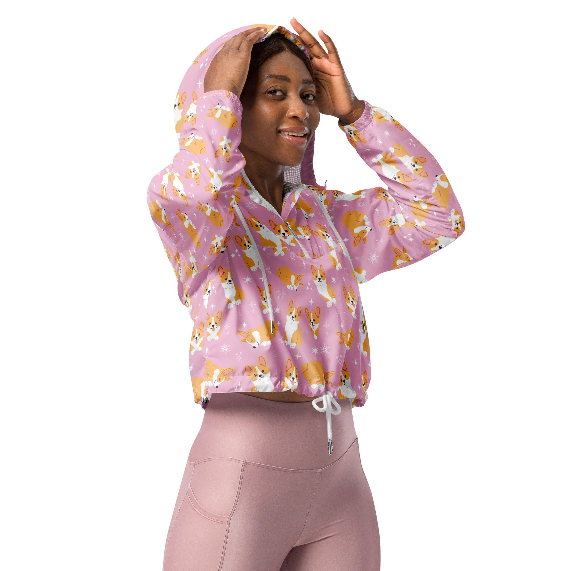 Women’s pink cropped hoodie with orange and white corgi pattern featuring drawstring hood and front zipper