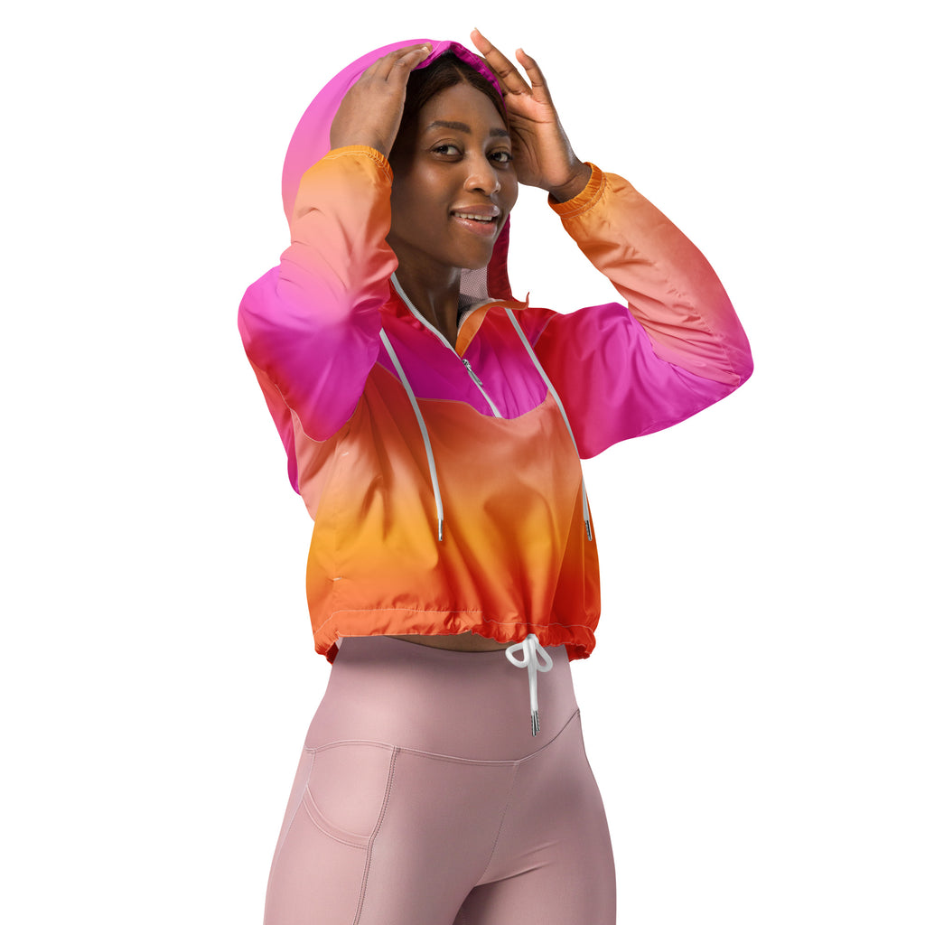 Women’s sunset ombre cropped windbreaker in vibrant pink and orange nylon with white drawstrings and adjustable hood