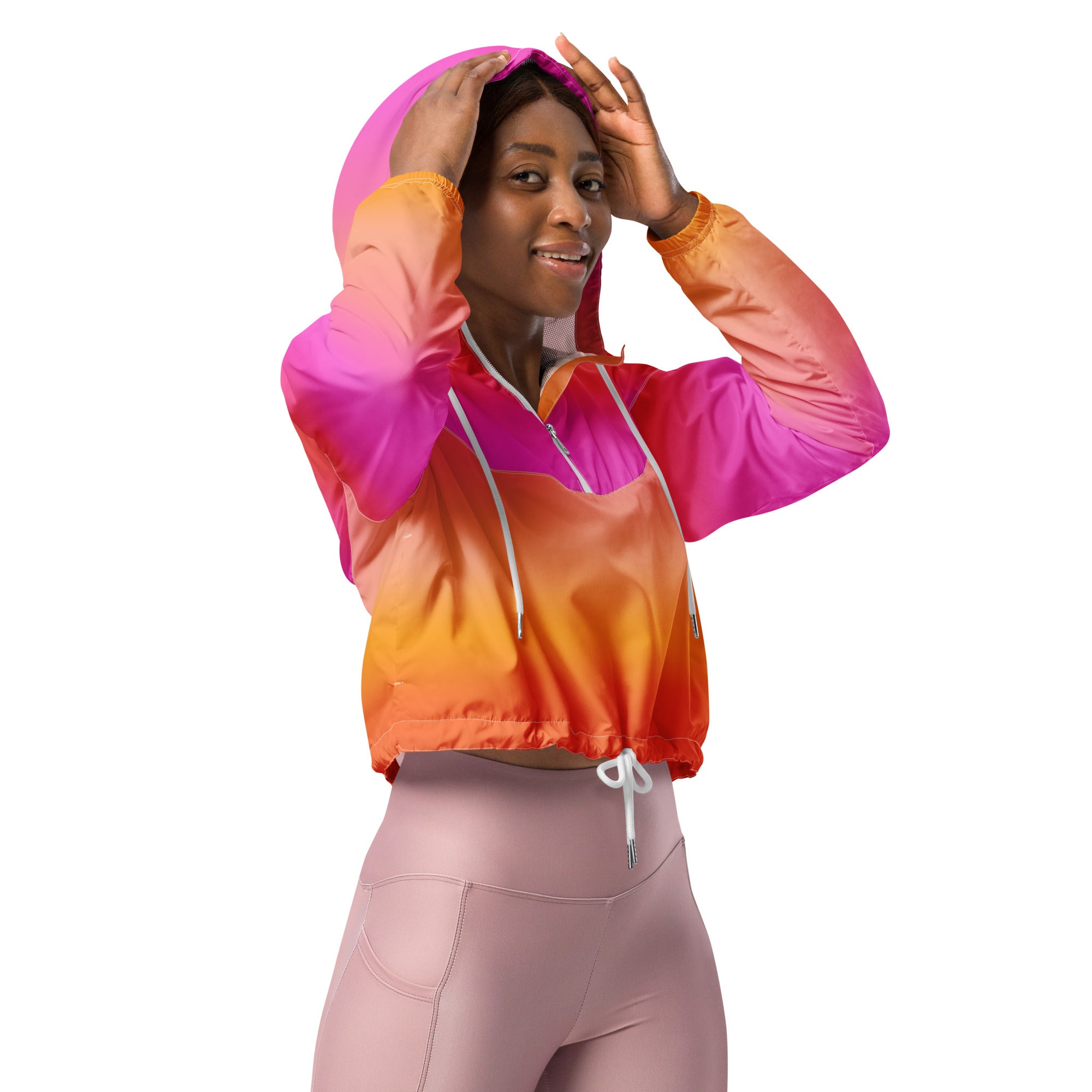 Women’s sunset ombre cropped windbreaker in vibrant pink and orange nylon with white drawstrings and adjustable hood