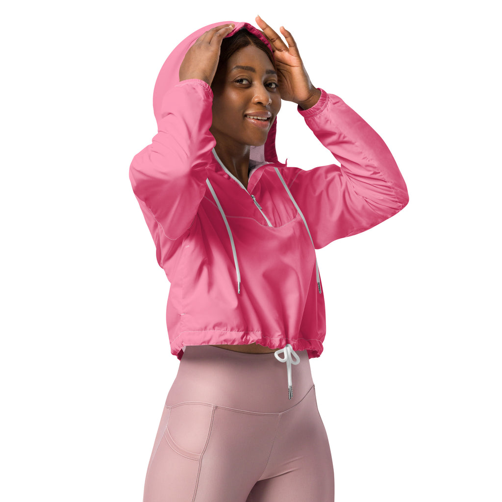 A vibrant pink cropped hooded windbreaker with white drawstrings and front zipper for lightweight water resistance
