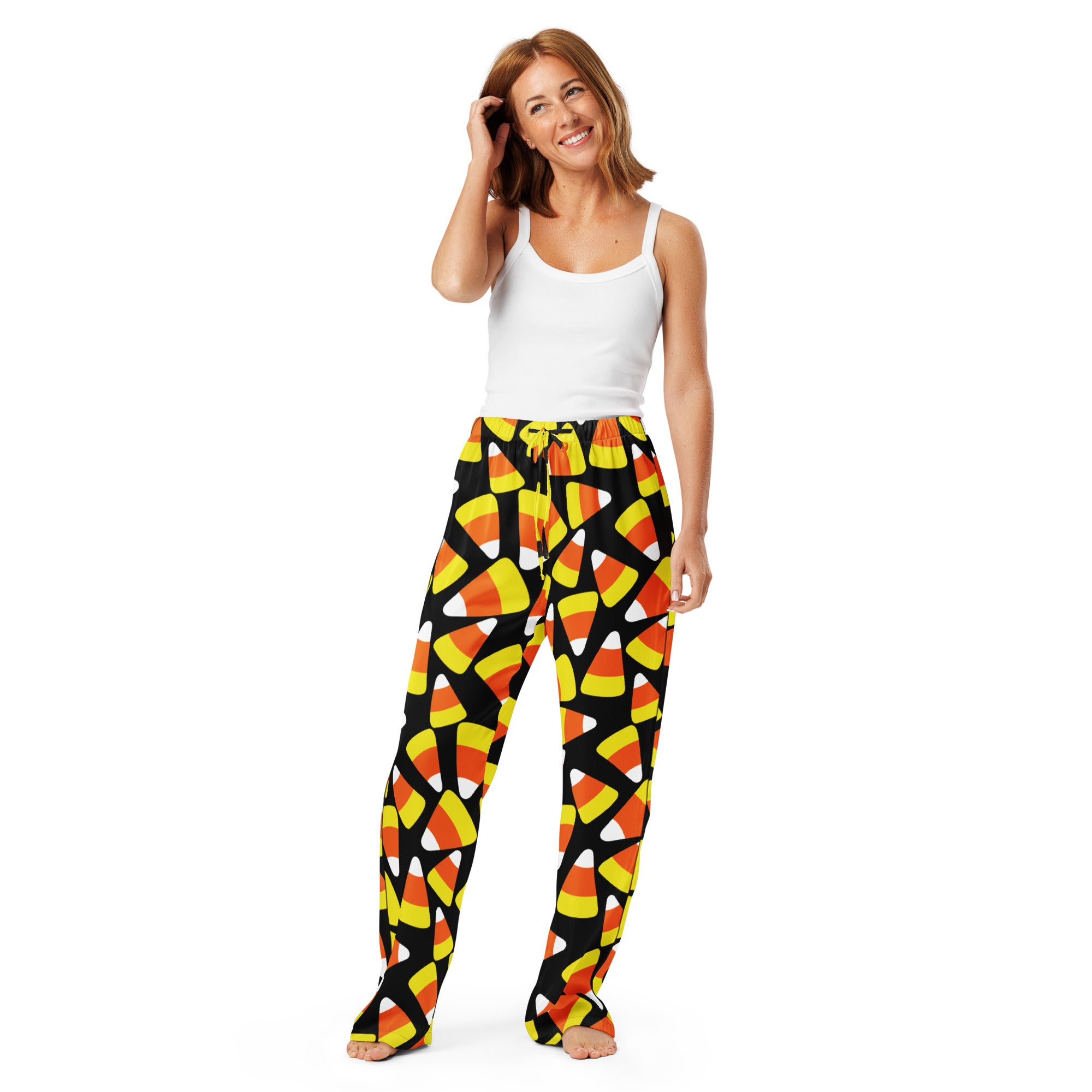 Women’s lightweight candy corn pajama pants with vibrant orange yellow white pattern and drawstring waist on black background