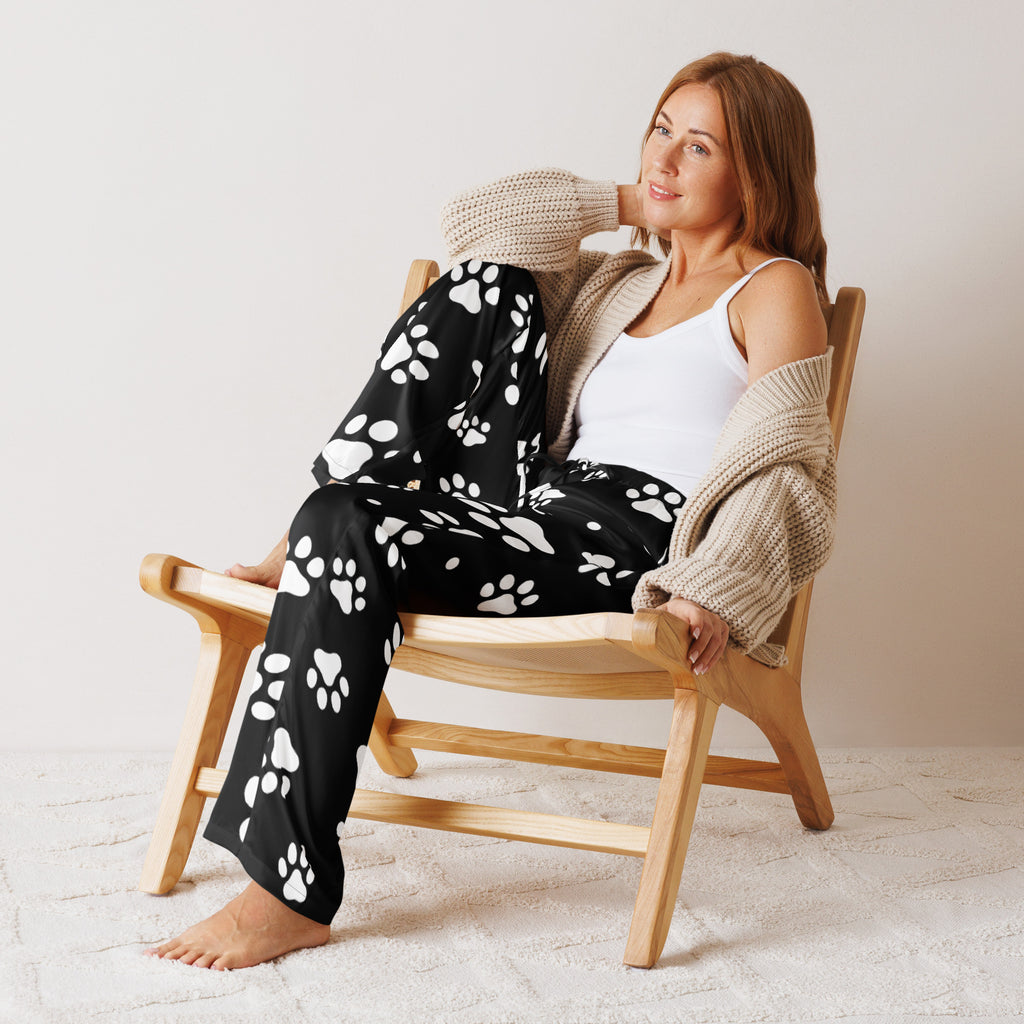 Women’s black lightweight pajama pants with white paw print pattern and relaxed fit featuring a drawstring waist