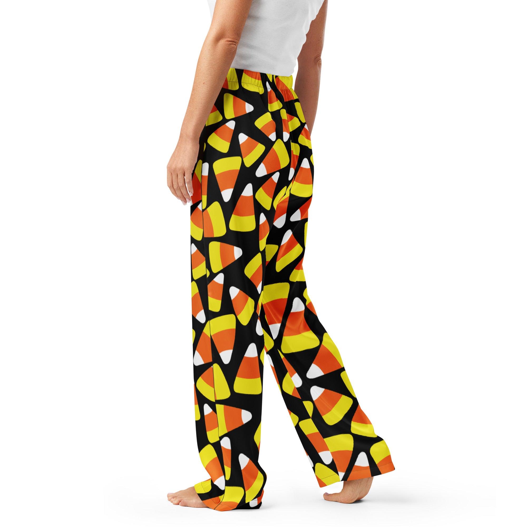 Women’s black lightweight candy cane pajama pants with vibrant orange yellow and white candy corn pattern and drawstring waist