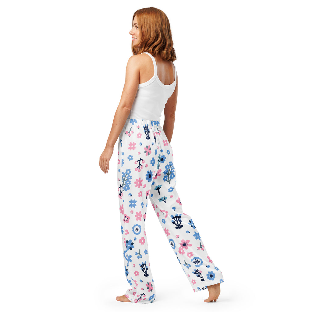 Women’s white pajama pants with pink and blue floral pattern and black stems made of soft flowing fabric with drawstring waist