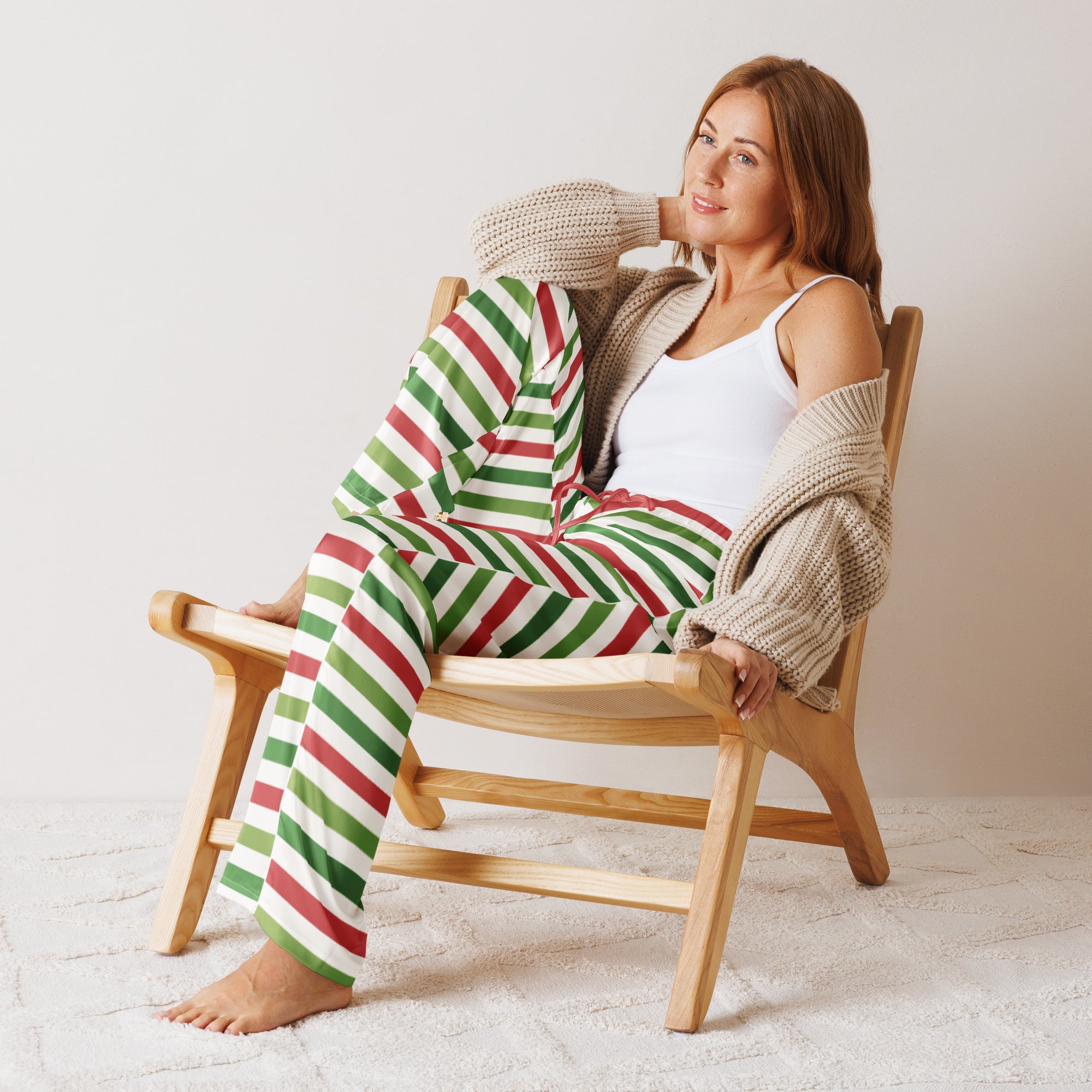 Woman wearing lightweight relaxed fit women’s christmas stripe pajama pants in red and green with drawstring waist