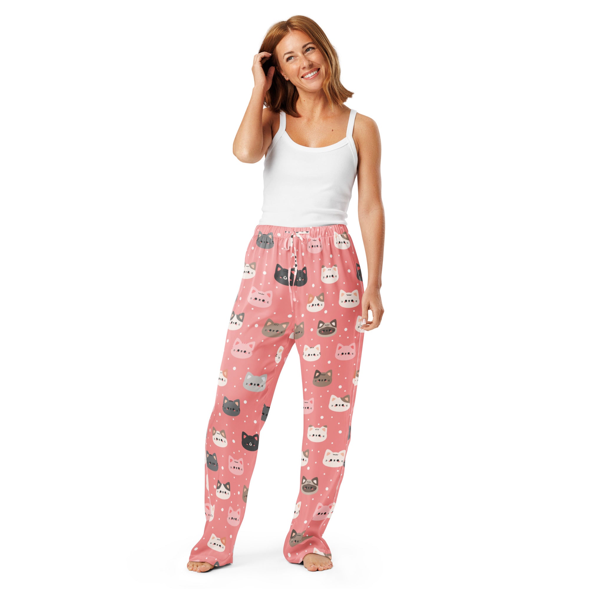 Women’s pink pajama pants with colorful cartoon cat faces in a lightweight relaxed fit and drawstring waist