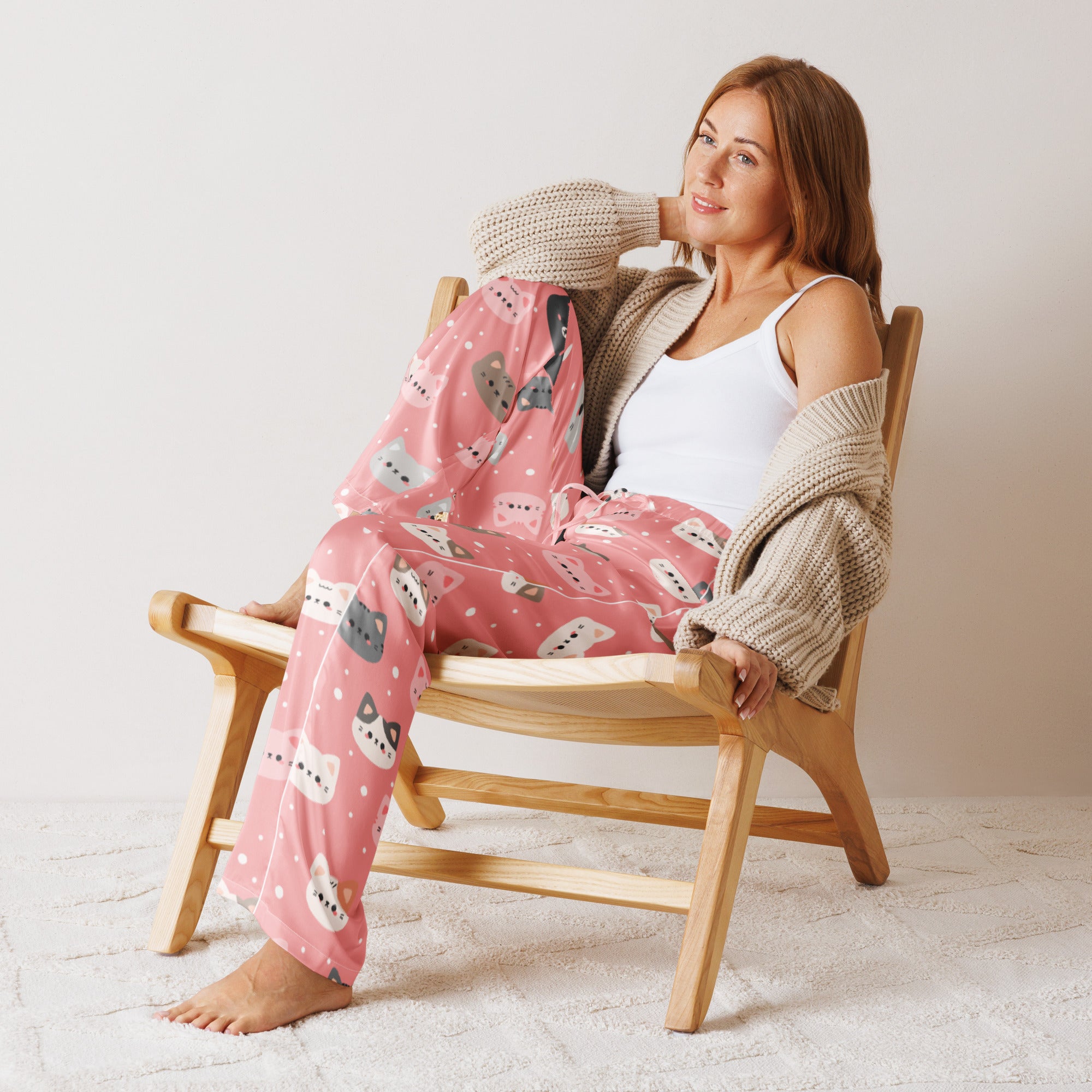 Women’s lightweight pink pajama pants with playful cartoon cat faces and white polka dots and drawstring waist