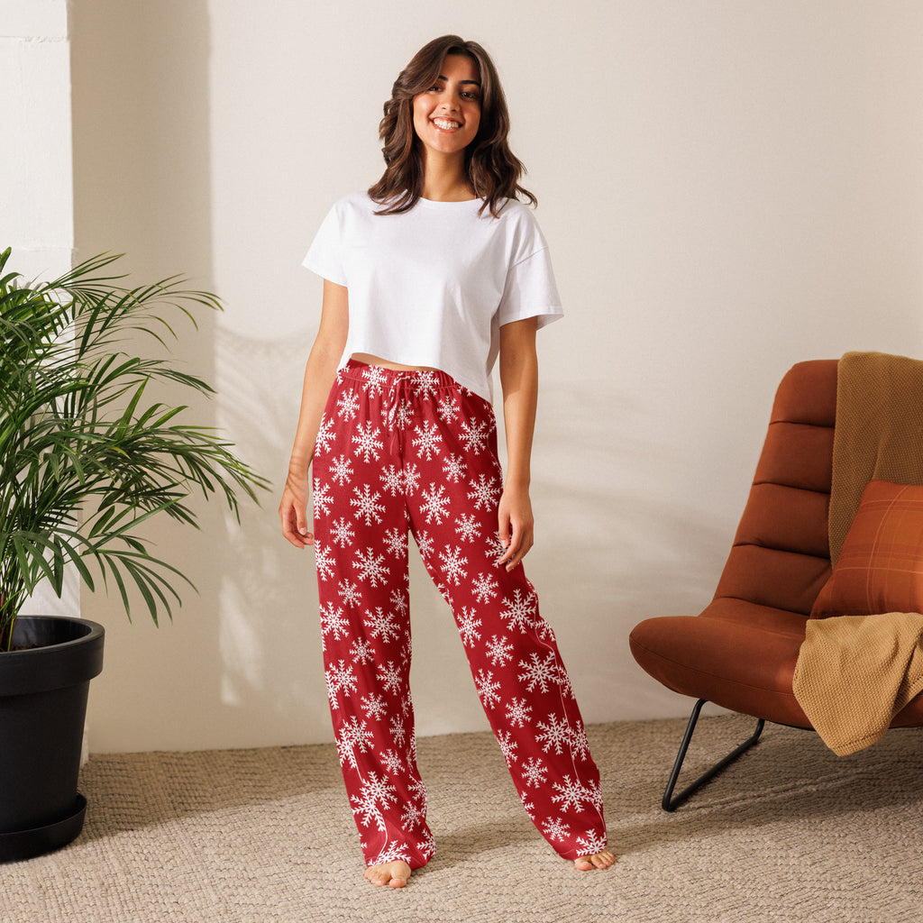 Women’s red lightweight pajama pants with white snowflake patterns and a relaxed fit with drawstring waist