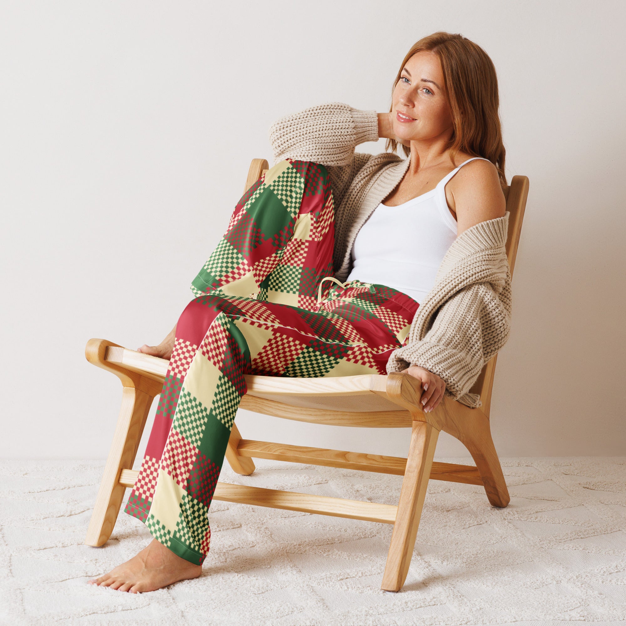 Woman wearing lightweight relaxed fit women’s Christmas plaid pajama pants in red green and beige with drawstring waist