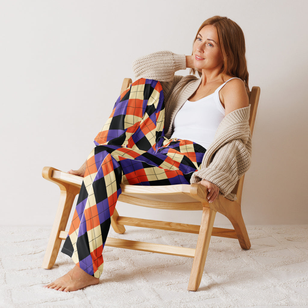 Woman wearing lightweight relaxed fit women’s halloween argyle pajama pants in purple orange black and cream with drawstring waist