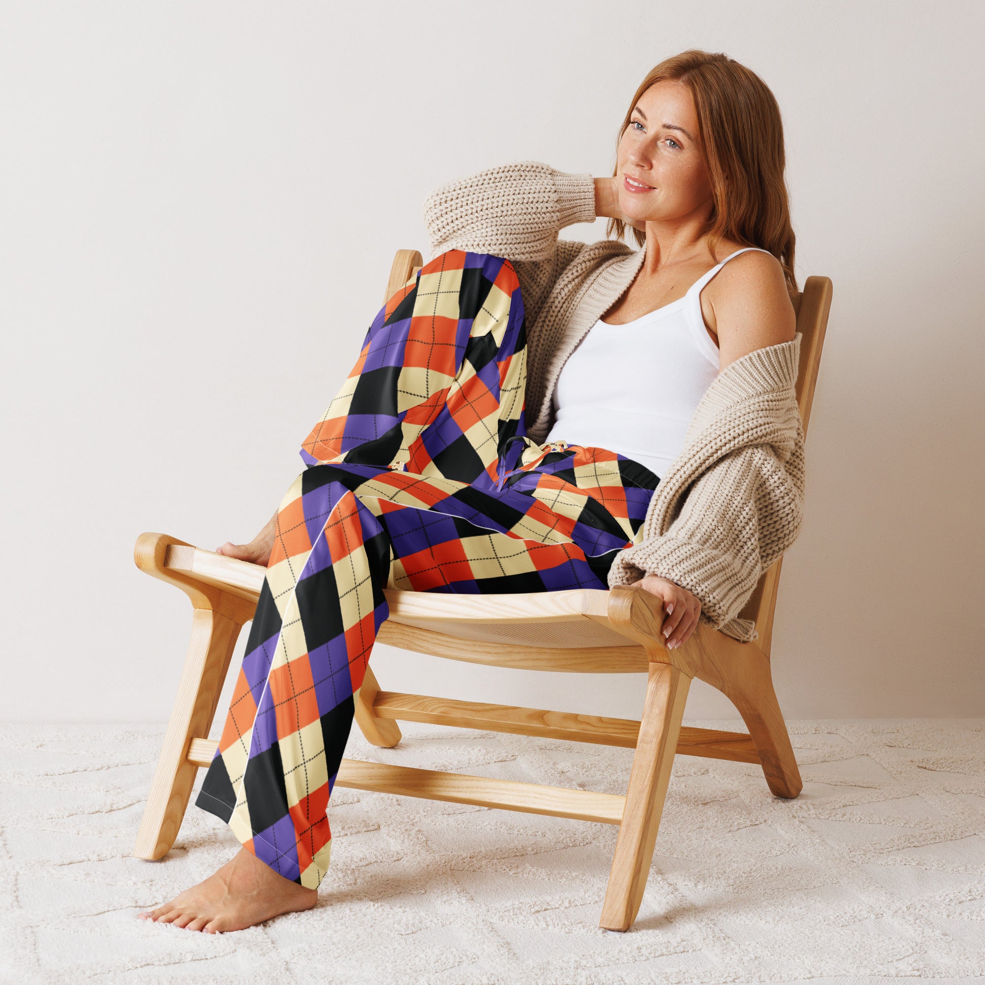 Woman wearing lightweight relaxed fit women’s halloween argyle pajama pants in purple orange black and cream with drawstring waist