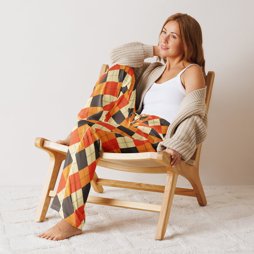 Woman wearing women’s fall argyle pajama pants in orange black and cream lightweight relaxed fit with drawstring waist