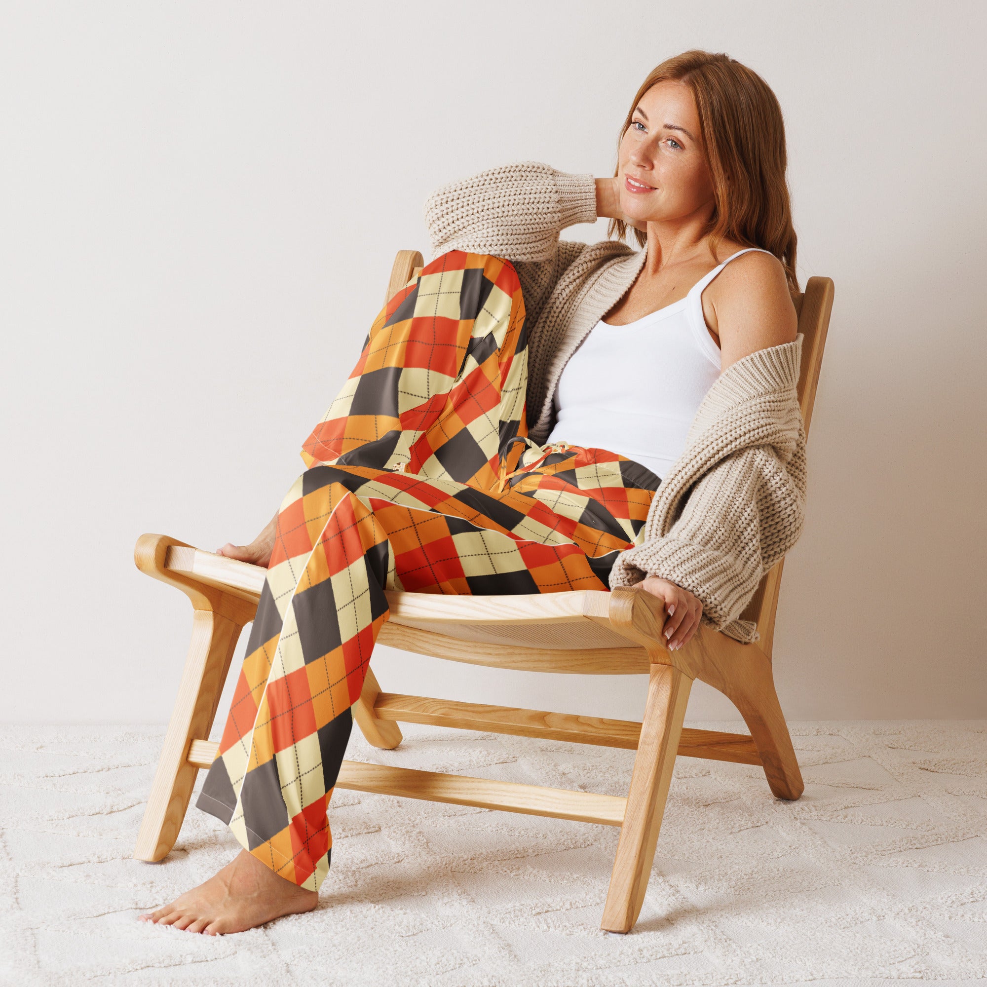 Woman wearing women’s fall argyle pajama pants in orange black and cream lightweight relaxed fit with drawstring waist