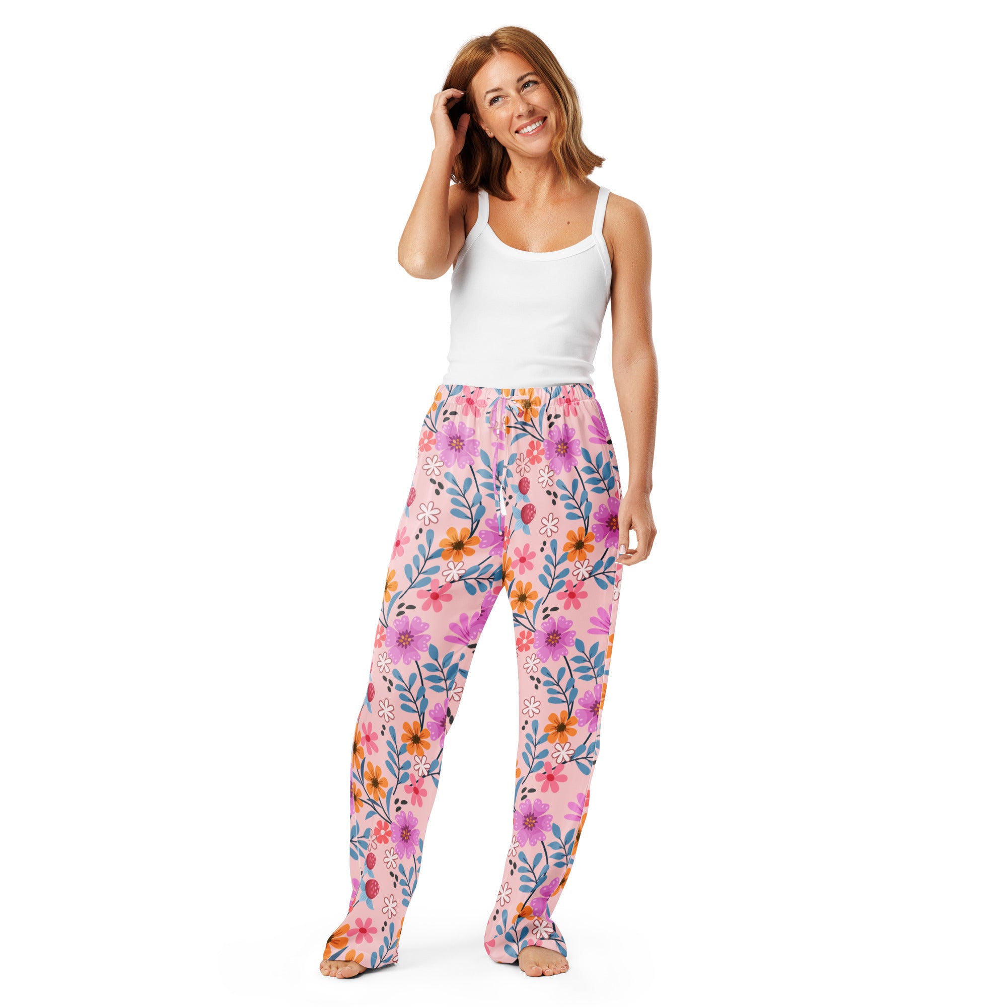 Women’s pink floral pajama pants with a lightweight relaxed fit, drawstring waist, and vibrant purple, orange, and blue blossoms