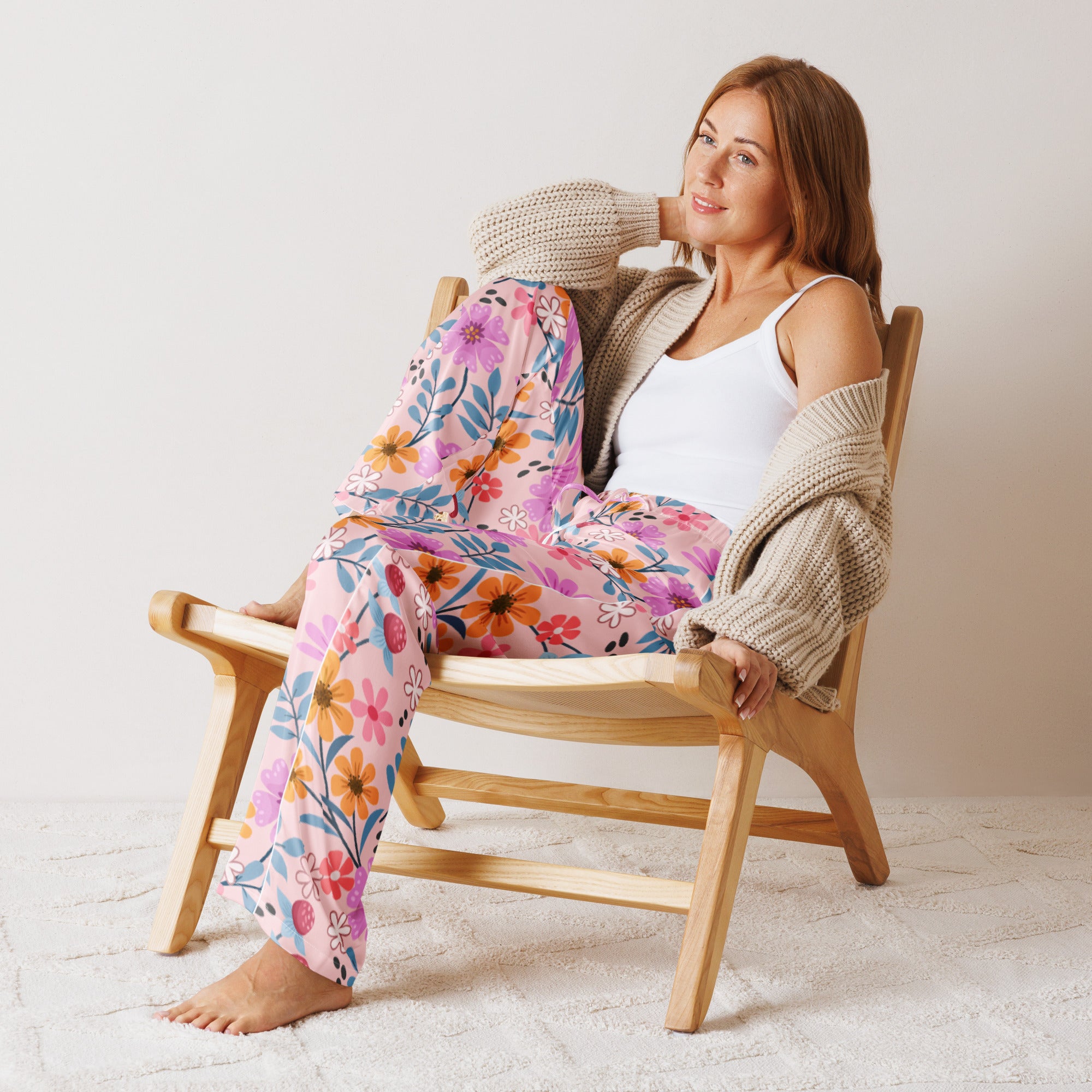 Women’s pink floral pajama pants with lightweight soft fabric vibrant orange purple blue and white blossoms and drawstring waist