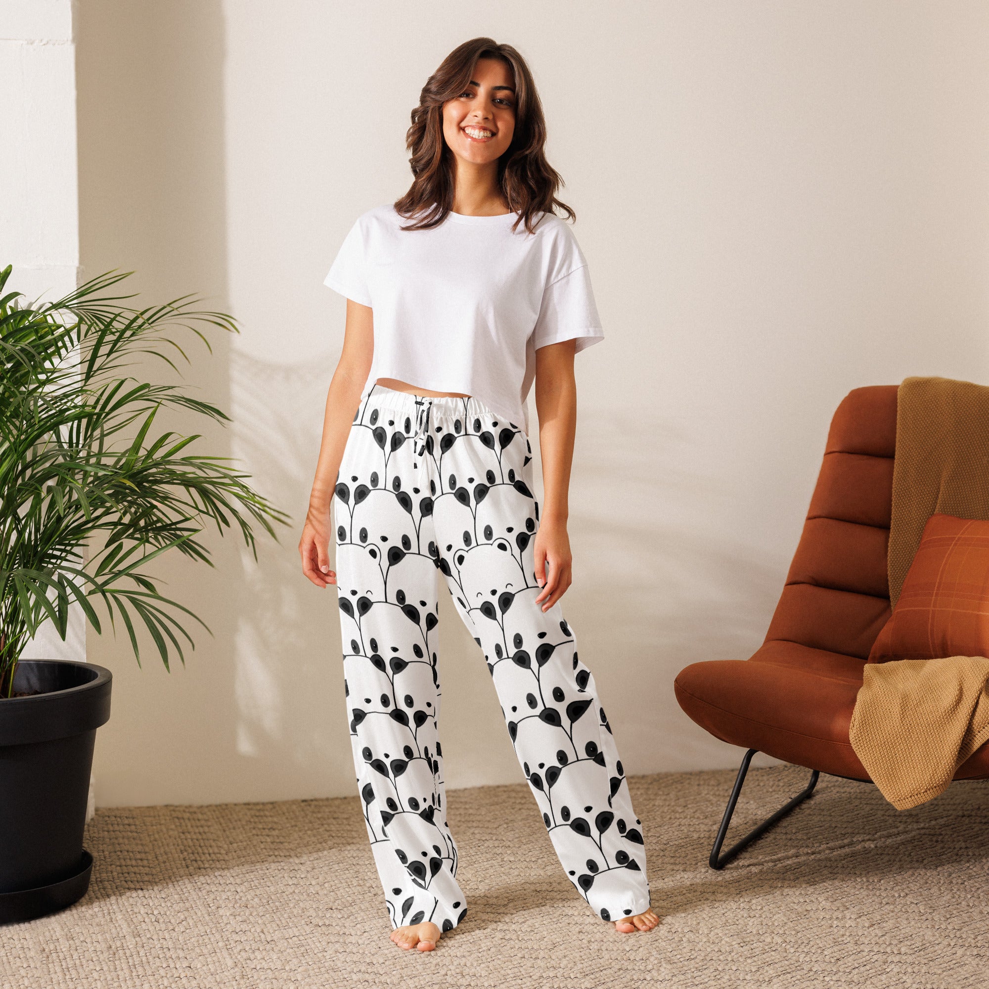 White women’s lightweight pajama pants with playful black panda face pattern and leafy vine design with drawstring waist