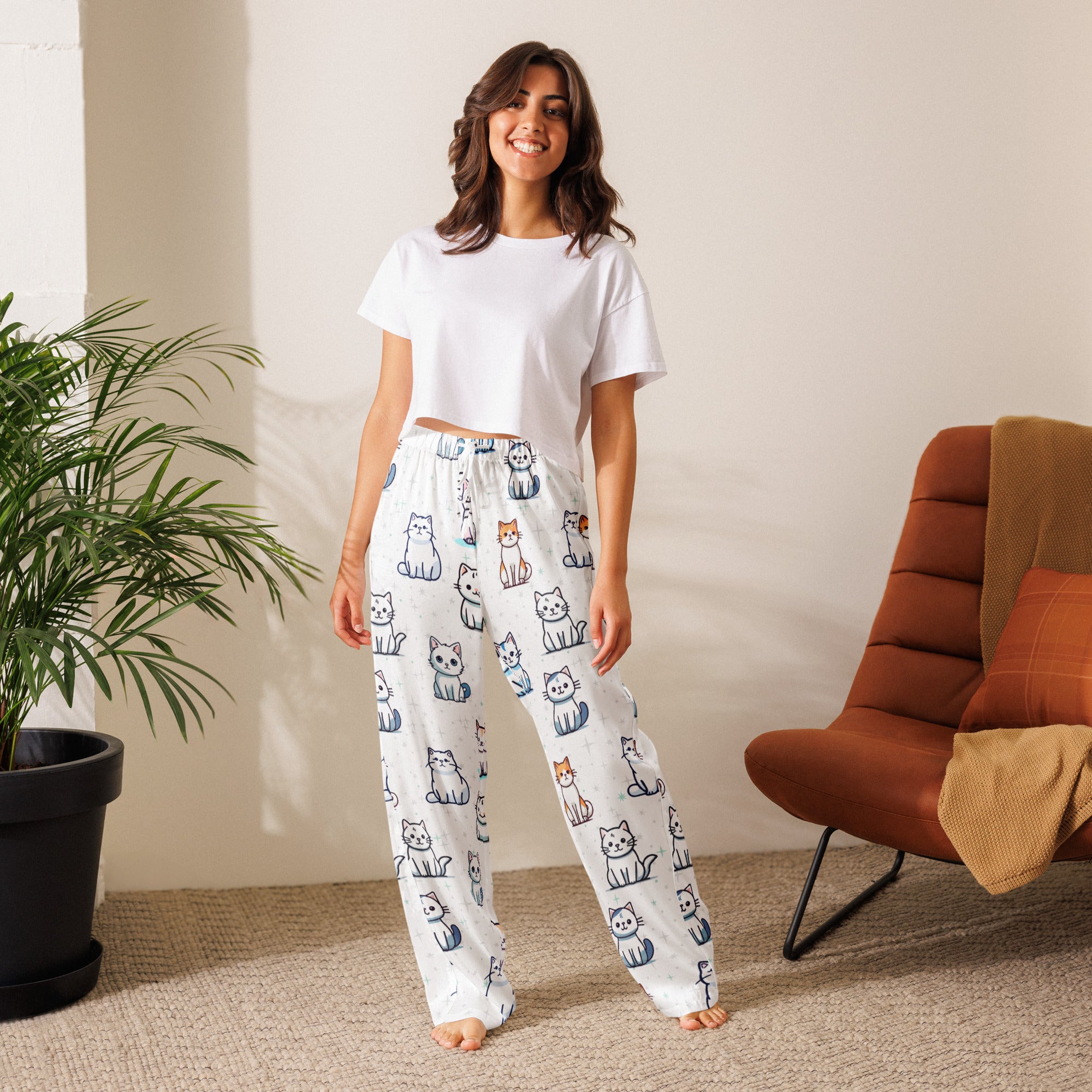 White women’s lightweight pajama pants with drawstring waist featuring playful cartoon cats in blue orange and gray
