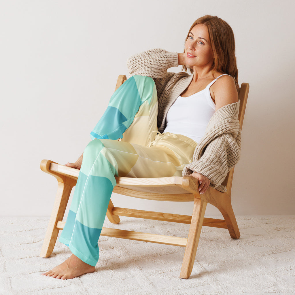 Woman wearing lightweight relaxed fit women’s ocean sunset pajama pants in teal and yellow gradient with drawstring waist