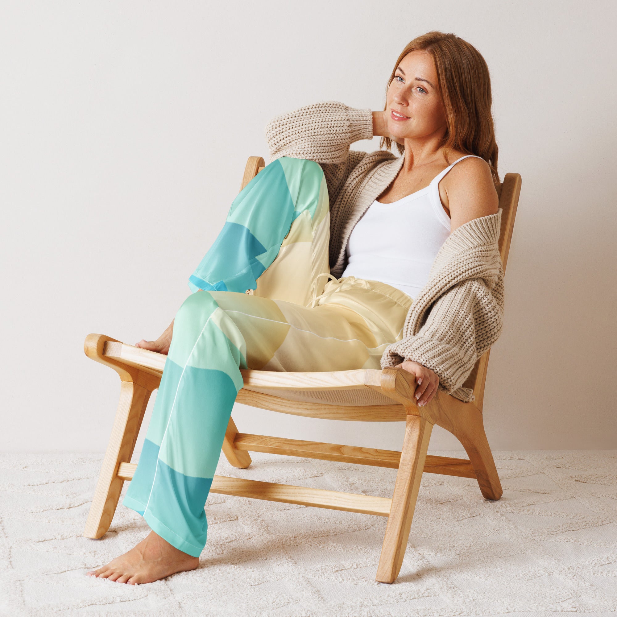 Woman wearing lightweight relaxed fit women’s ocean sunset pajama pants in teal and yellow gradient with drawstring waist