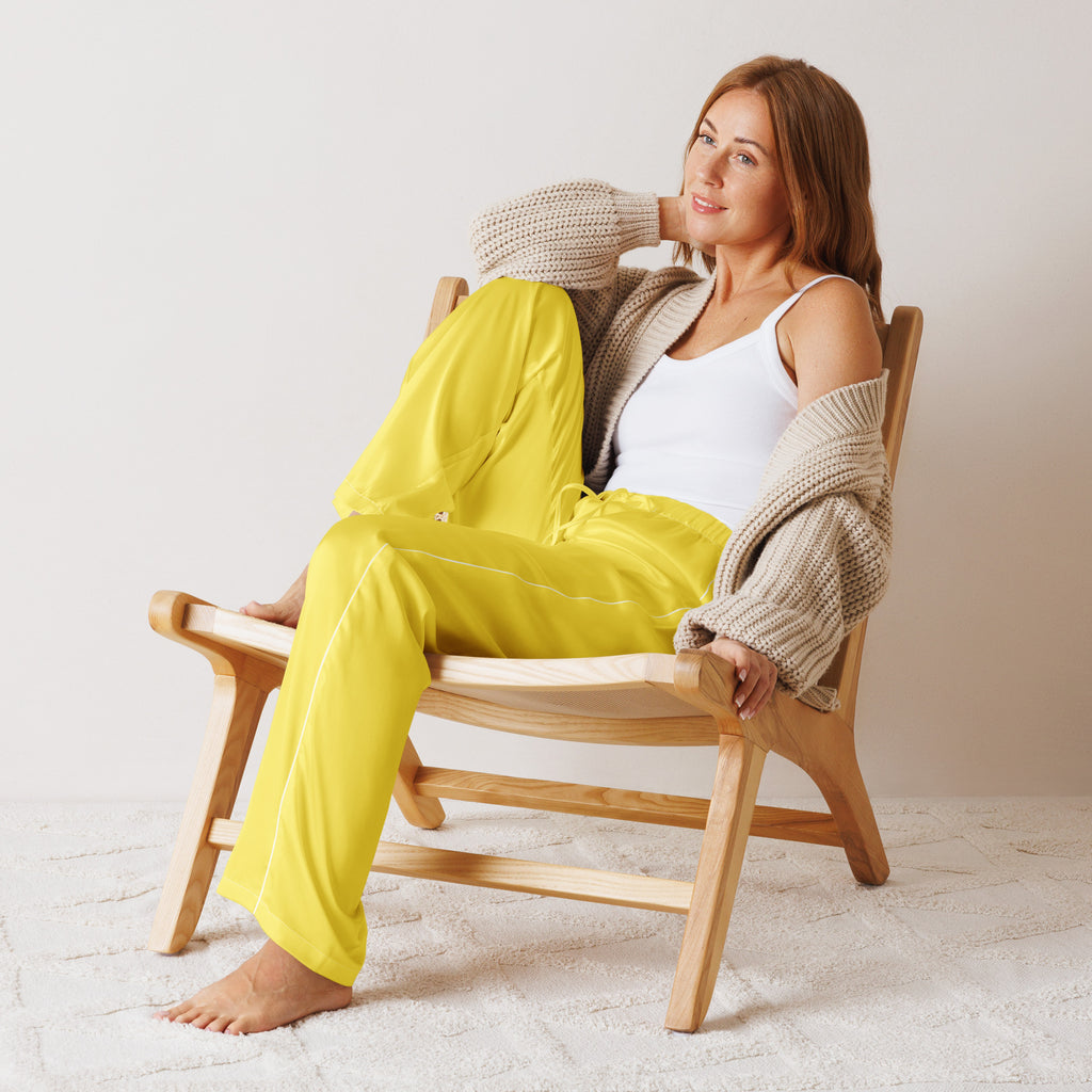 Bright yellow satin pajama pants for women with a lightweight relaxed fit and drawstring waist detail