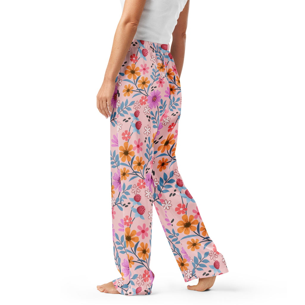 Women’s pink floral pajama pants with wide-leg fit soft flowing fabric and vibrant orange purple and blue blossoms