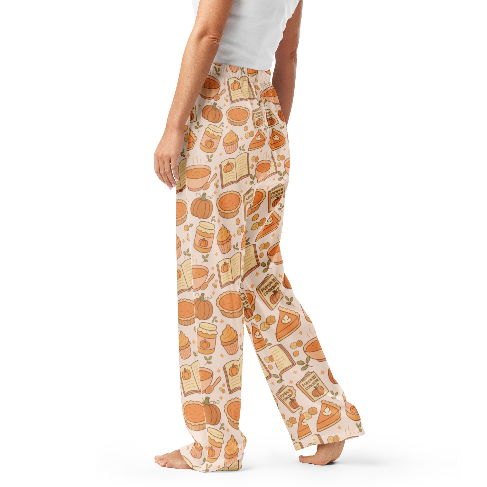 Cream-colored women’s pumpkin pie themed lightweight pajama pants with playful pumpkin pie pie cupcake and book pattern