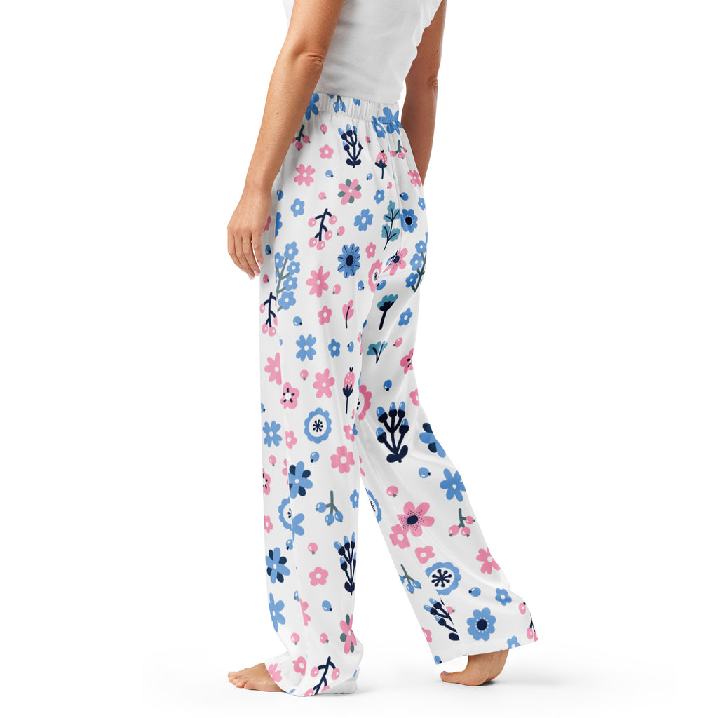 Women’s white pajama pants with pink and blue floral pattern and black stems made from soft flowing fabric