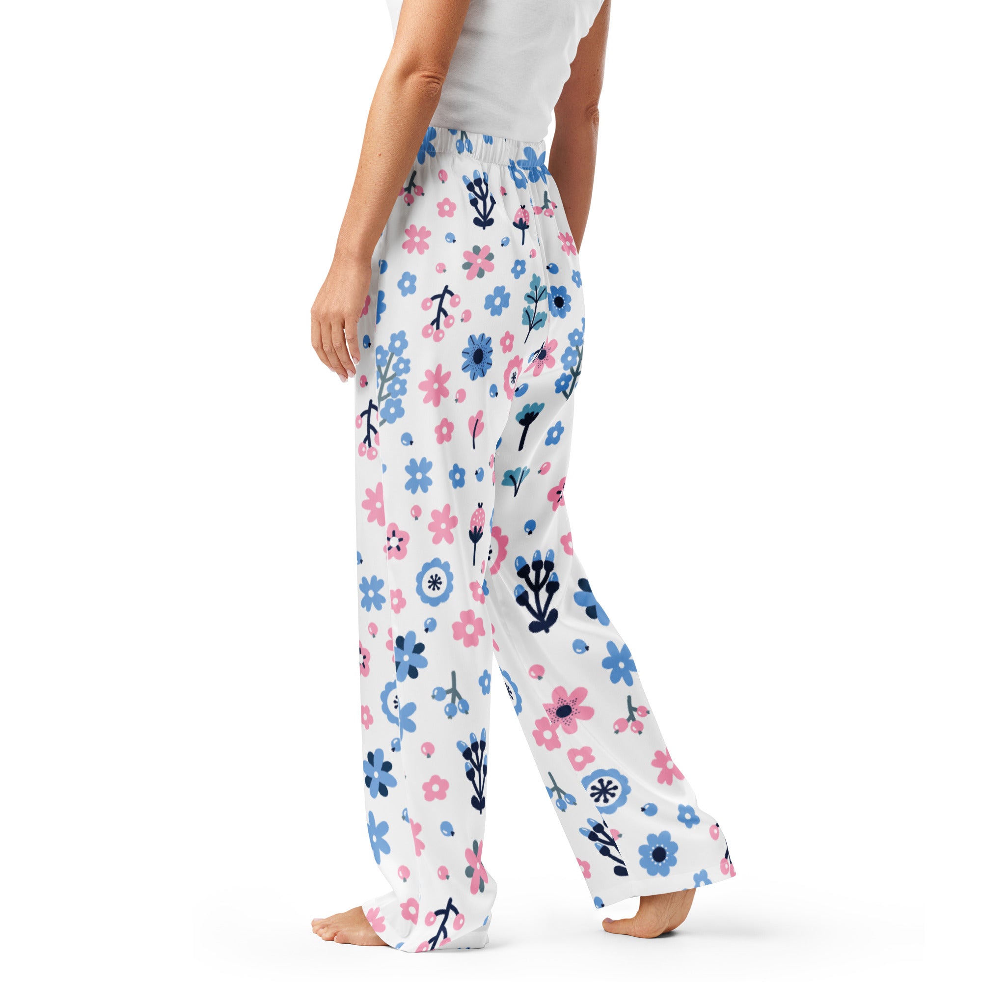 Women’s white pajama pants with pink and blue floral pattern and black stems made from soft flowing fabric