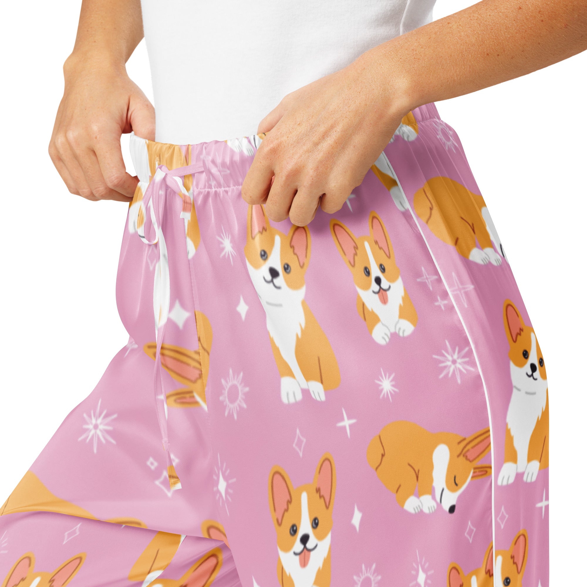 Women’s pink lightweight corgi dog pajama pants with playful orange and white corgis and star accents and drawstring waist
