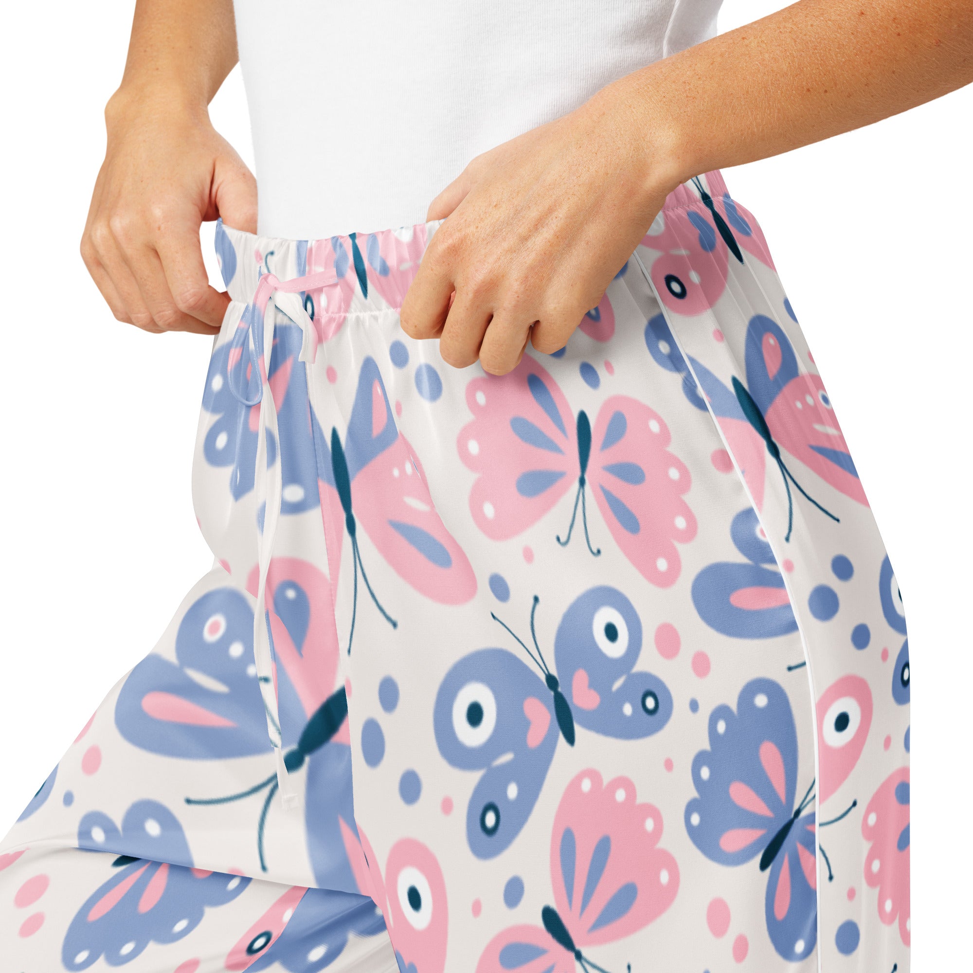 White lightweight women’s pajama pants with pink and blue cartoon butterflies and polka dots, relaxed fit with drawstring waist