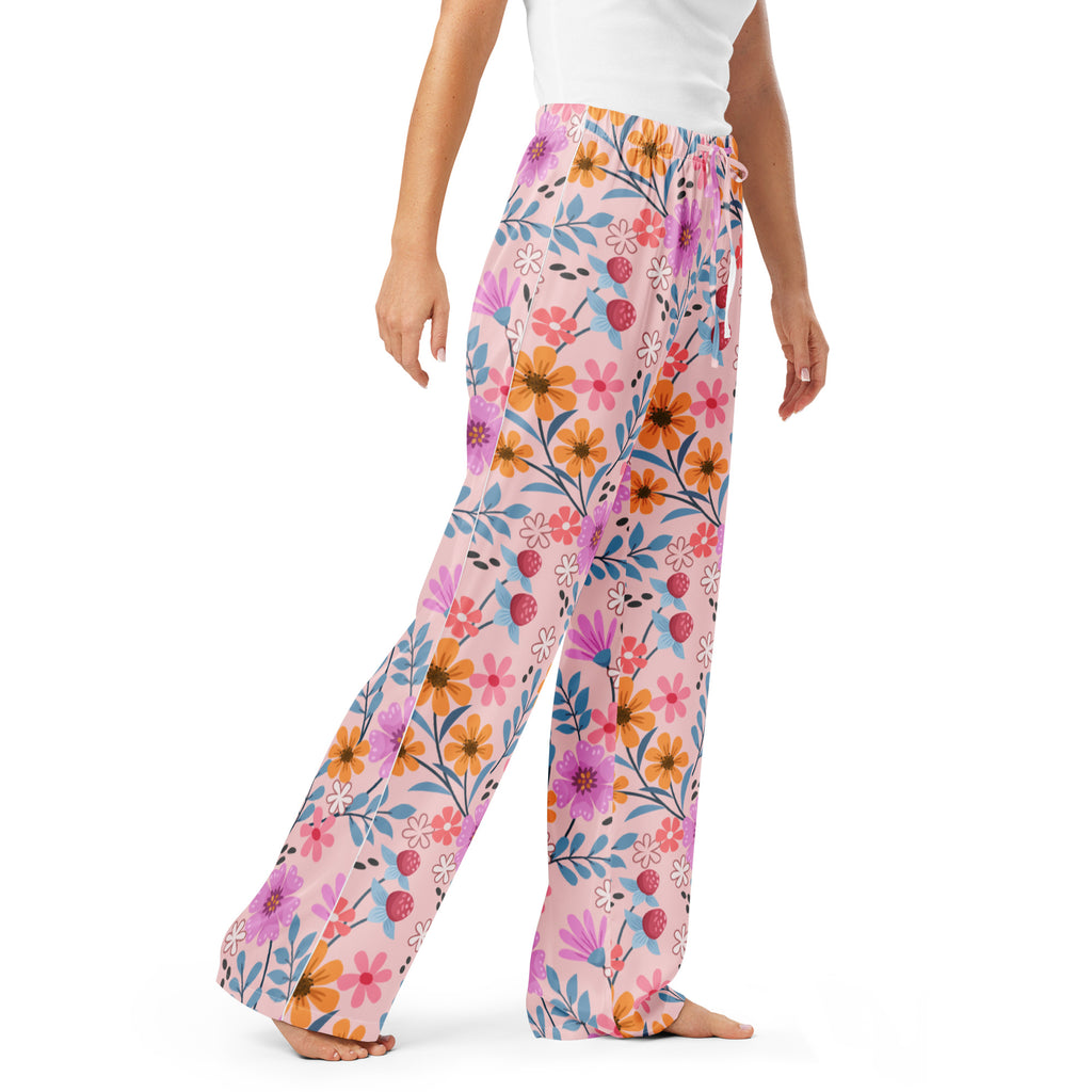 Women’s pink floral wide-leg pajama pants with vibrant orange purple and blue flowers and drawstring waist