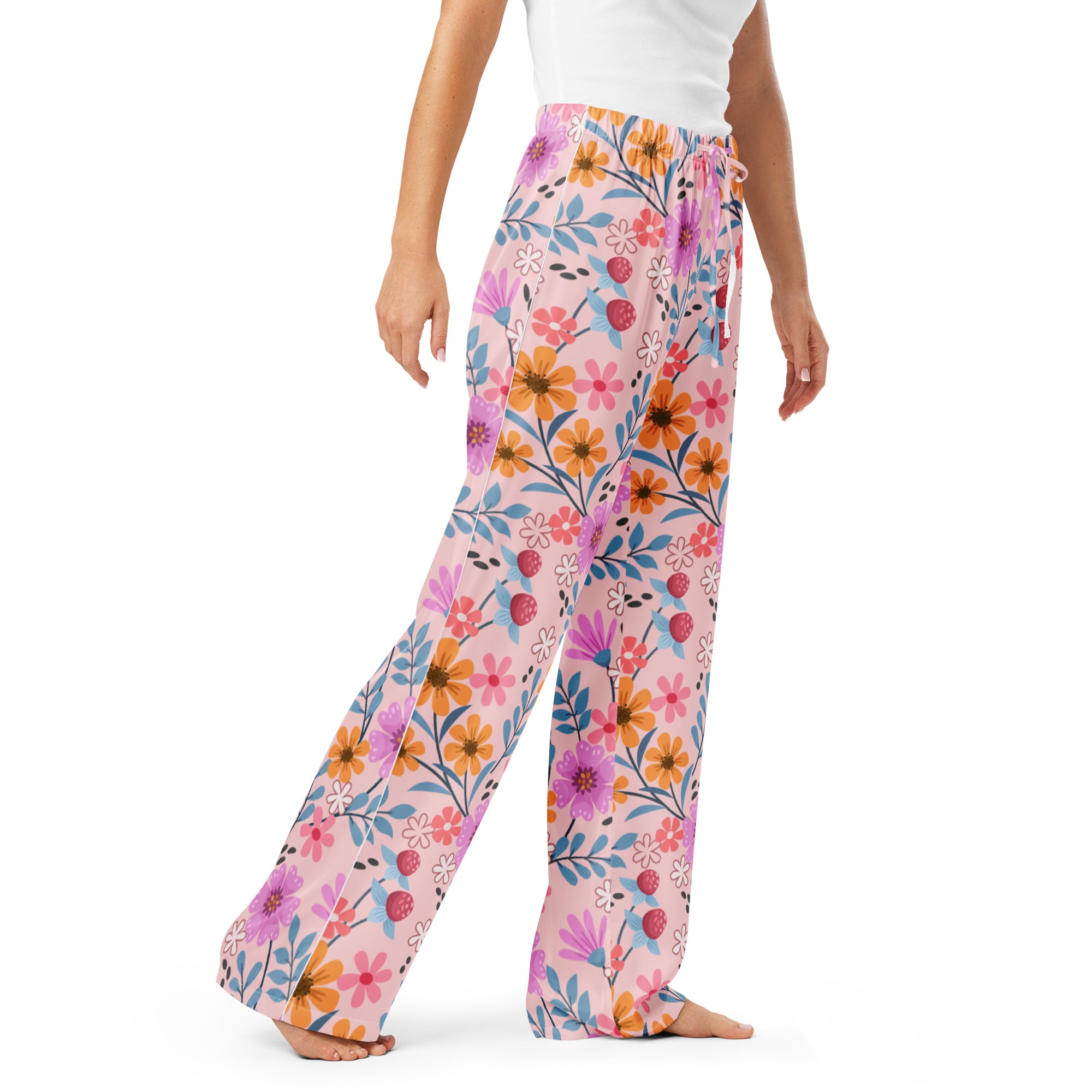 Women’s pink floral wide-leg pajama pants with vibrant orange purple and blue flowers and drawstring waist