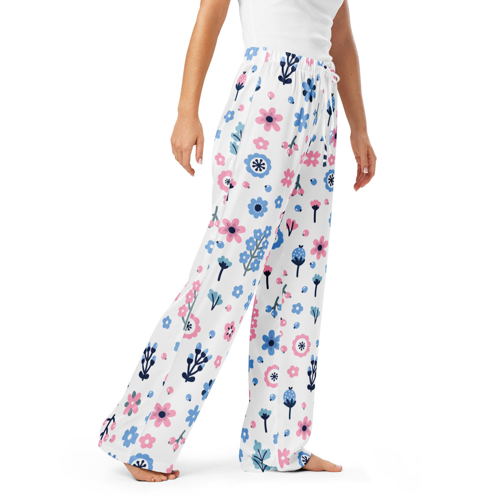 Women’s white pajama pants with pink and blue floral pattern on soft flowing fabric featuring a drawstring waist