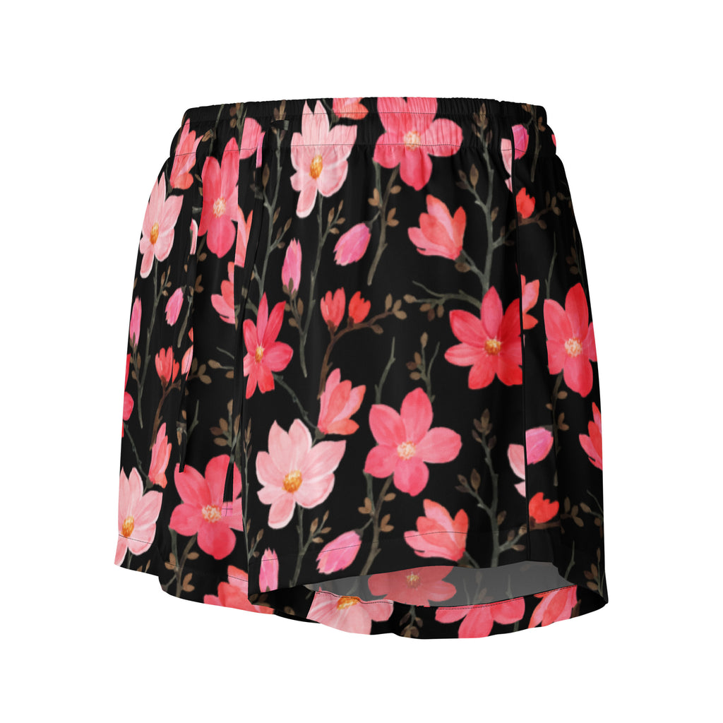 Black pleated skirt with vibrant pink and coral watercolor floral pattern and delicate green stems in silky fabric