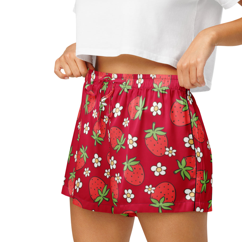 Women’s red silky pajama shorts with playful strawberry and white flower pattern, elastic waistband, and drawstring fit