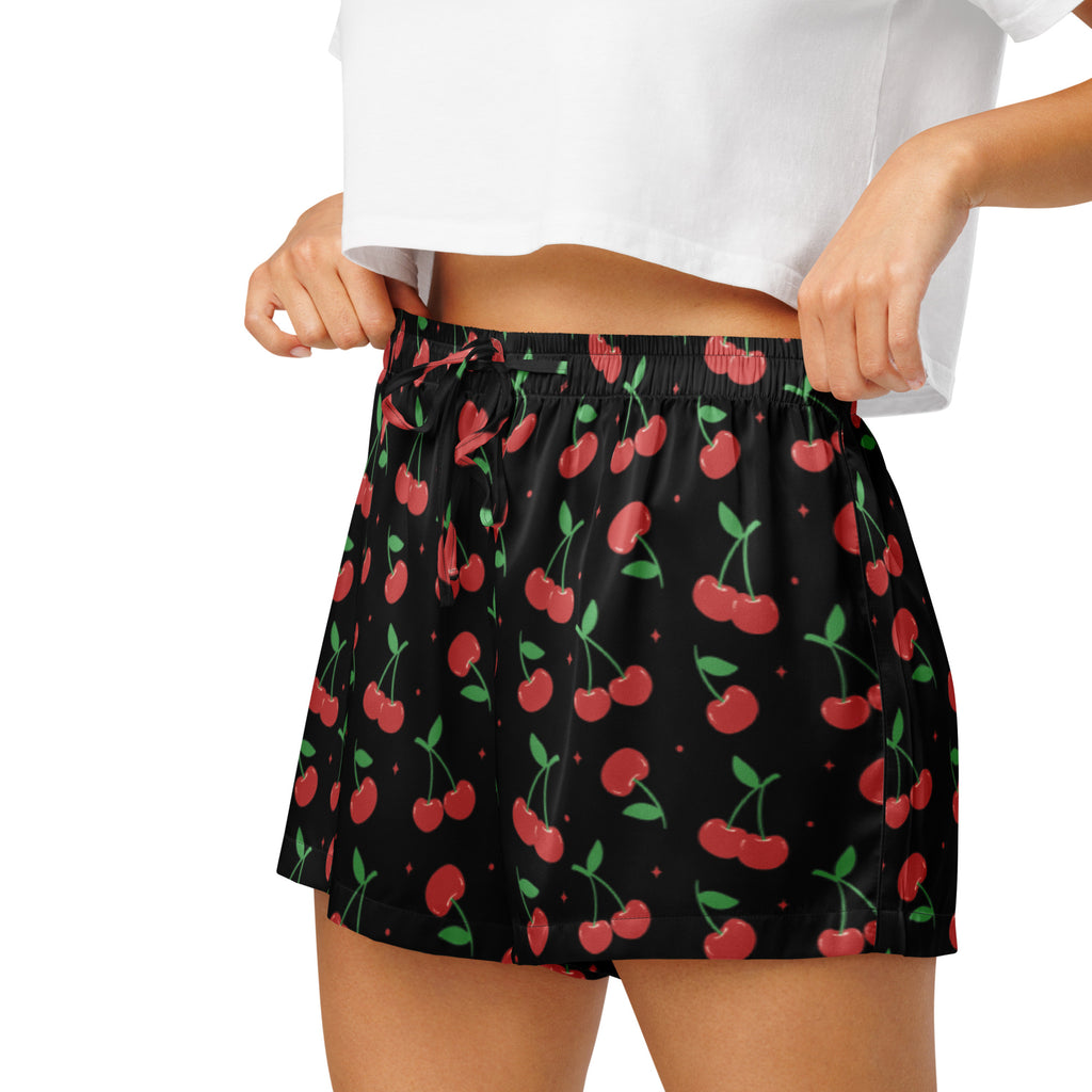 Women’s black silky pajama shorts with vibrant red cherry pattern and green stems in lightweight relaxed fit