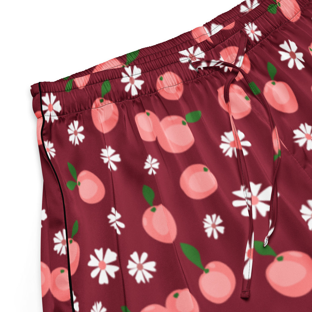 Women’s burgundy silky pajama shorts with pink peach and white daisy pattern and black piping on side seam