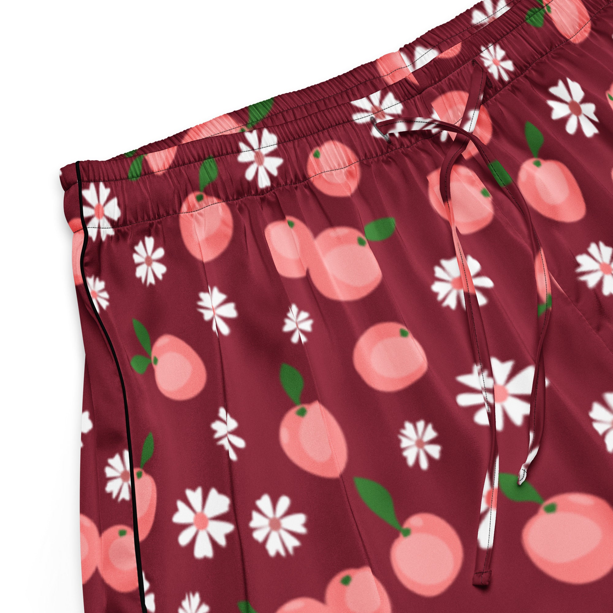 Women’s burgundy silky pajama shorts with pink peach and white daisy pattern and black piping on side seam