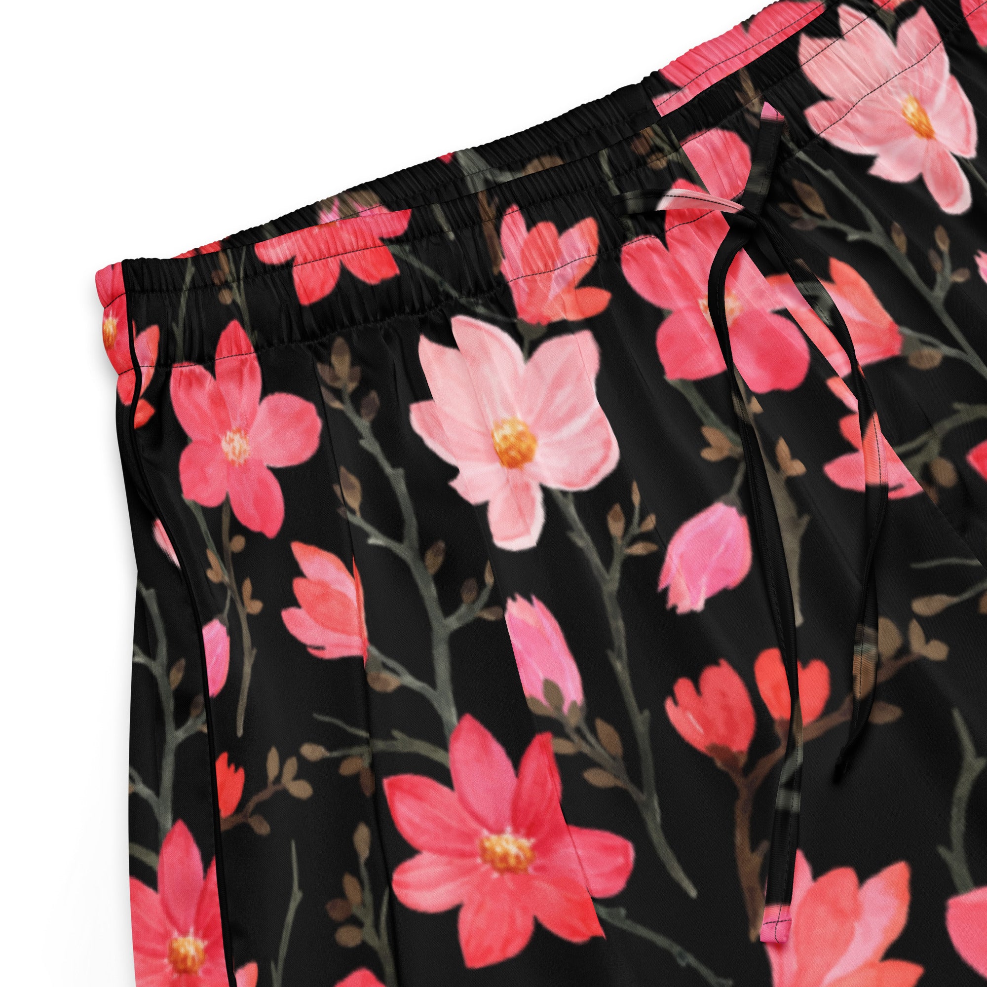 Women’s black silky pajama pants with vibrant pink magnolia flowers and gray branches in a relaxed fit with drawstring waist