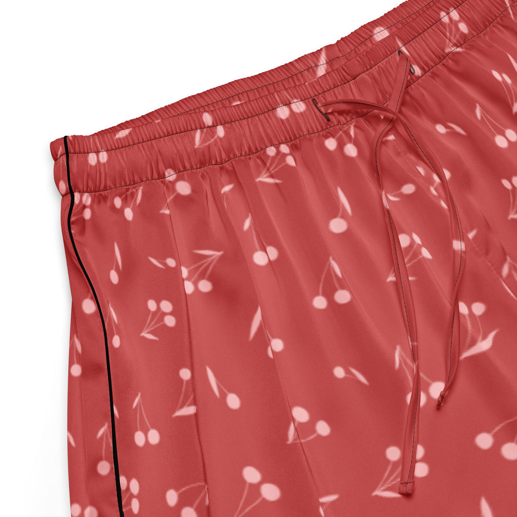 Women’s lightweight red satin pajama pants with cherry print and black side seam piping for relaxed fit comfort