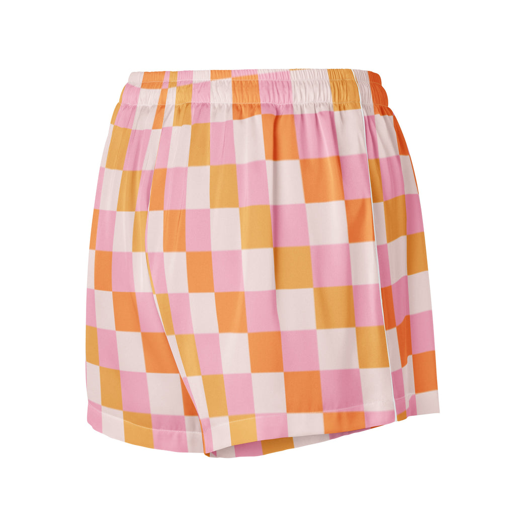 Women’s pink and orange checkered silky pajama shorts with a white elastic waistband and lightweight relaxed fit