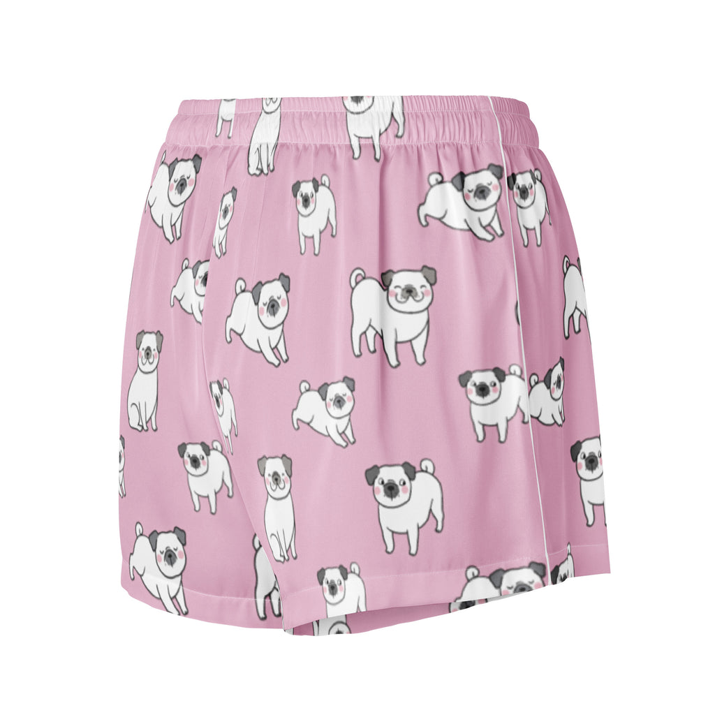 Women’s pink silky pajama shorts with a playful white pug pattern and a lightweight relaxed fit with drawstring waist