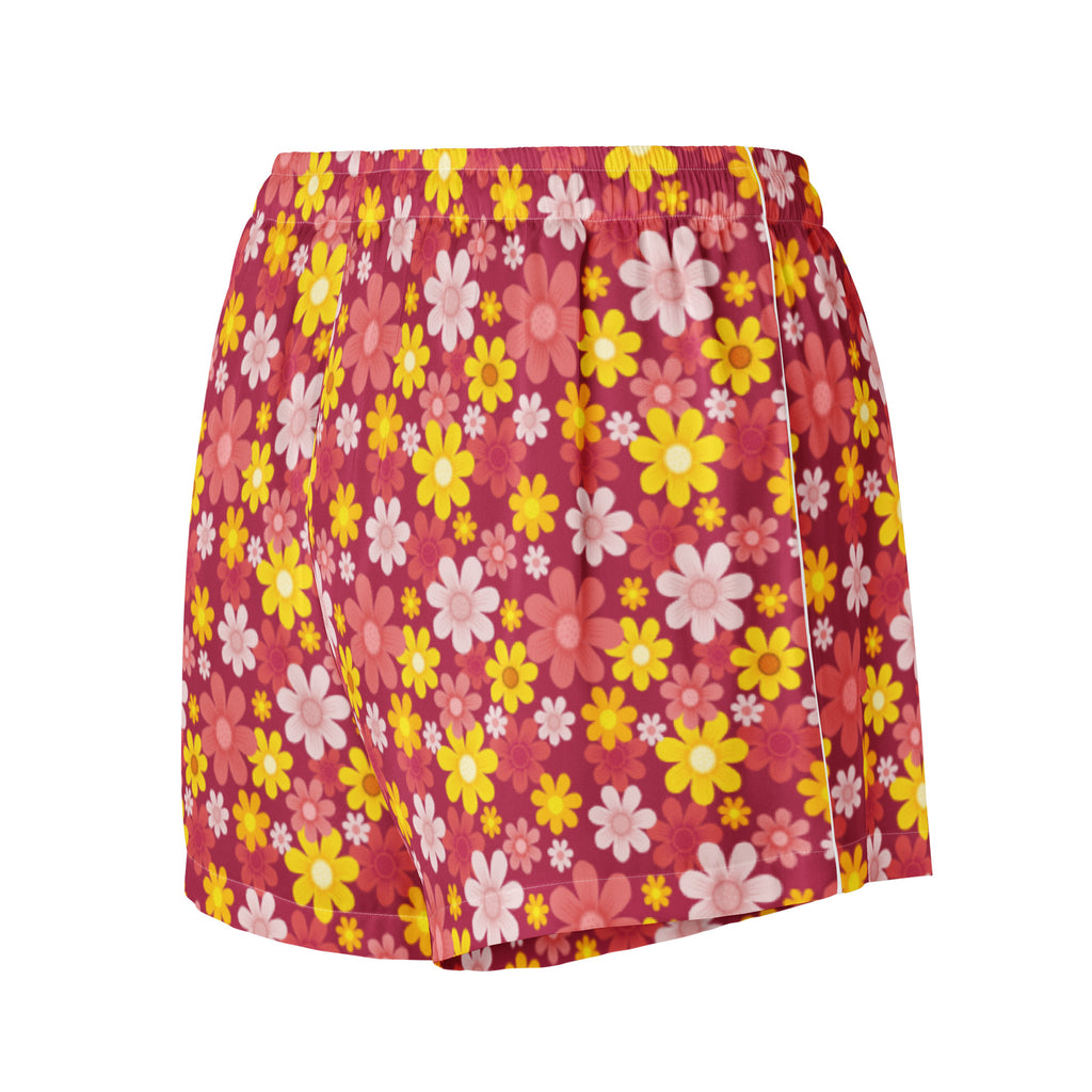 Women’s red floral silky pajama shorts with vibrant pink daisy pattern on textured lightweight fabric and drawstring waist
