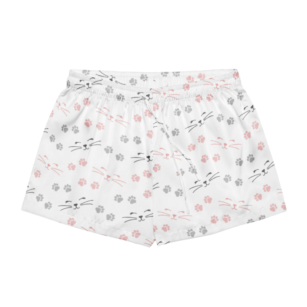 Women’s white silky pajama shorts with pink and gray cat faces and paw prints featuring a drawstring waist