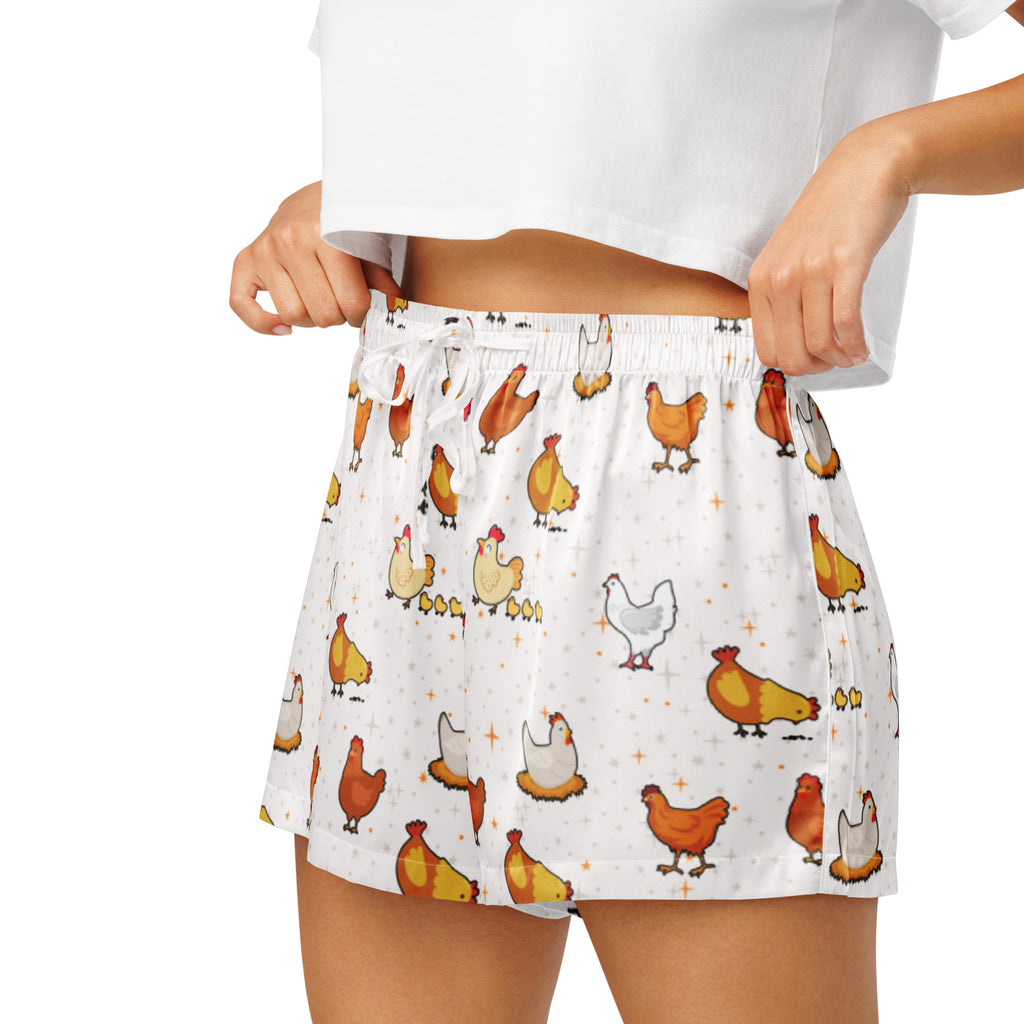 White silky women’s pajama shorts with a playful colorful cartoon chicken pattern and a lightweight drawstring waist