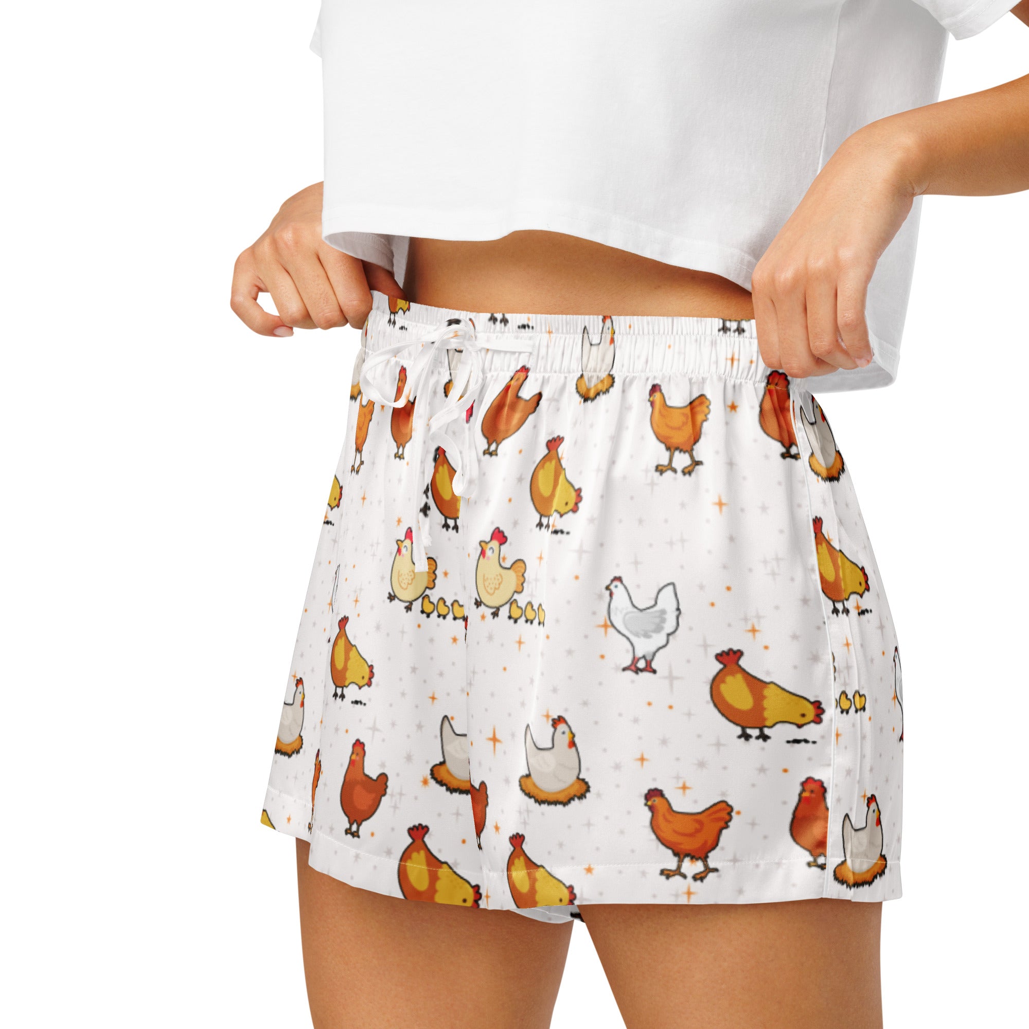 White silky women’s pajama shorts with a playful colorful cartoon chicken pattern and a lightweight drawstring waist