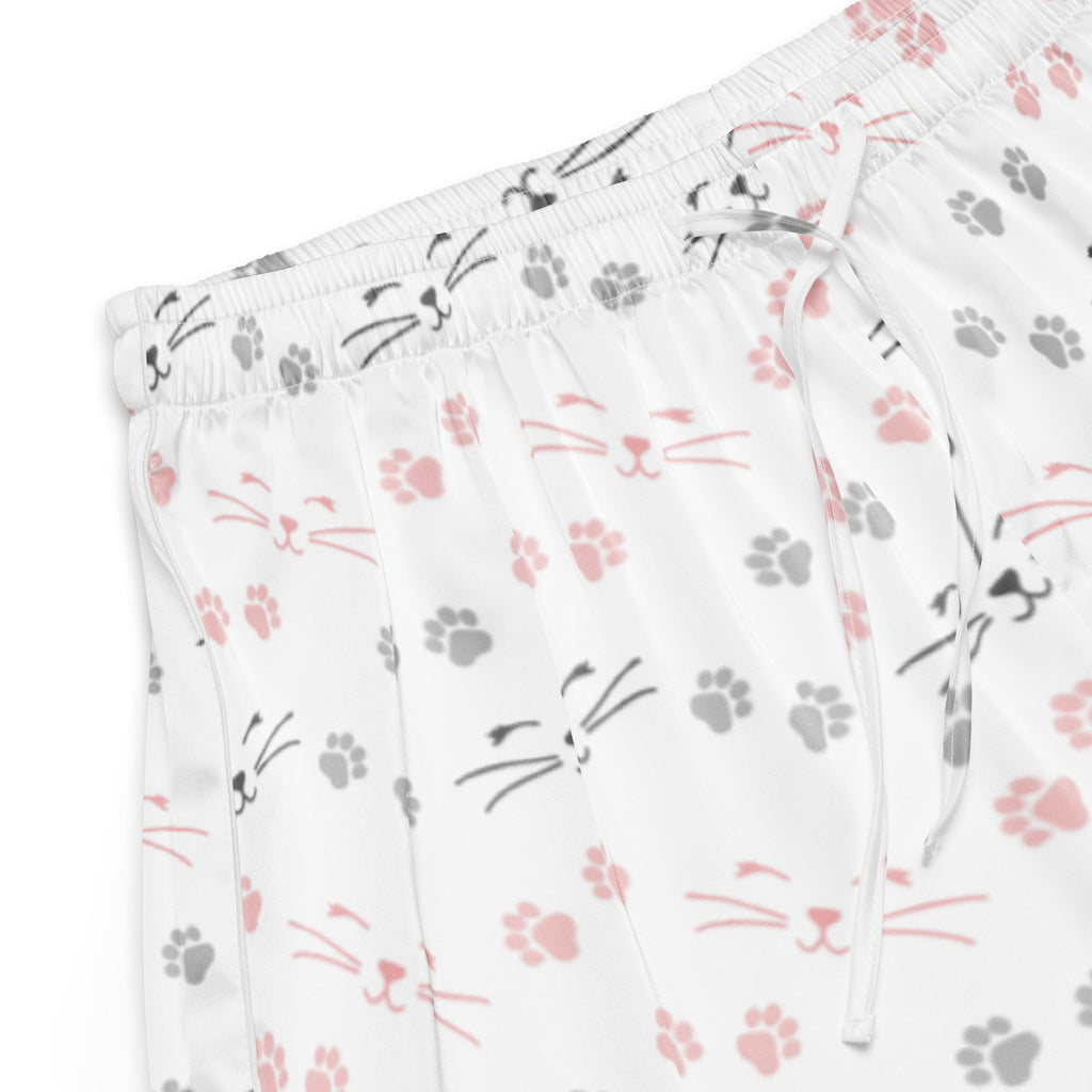 White silky pajama shorts with pink and gray cat faces and paw prints featuring a lightweight relaxed fit and drawstring waist