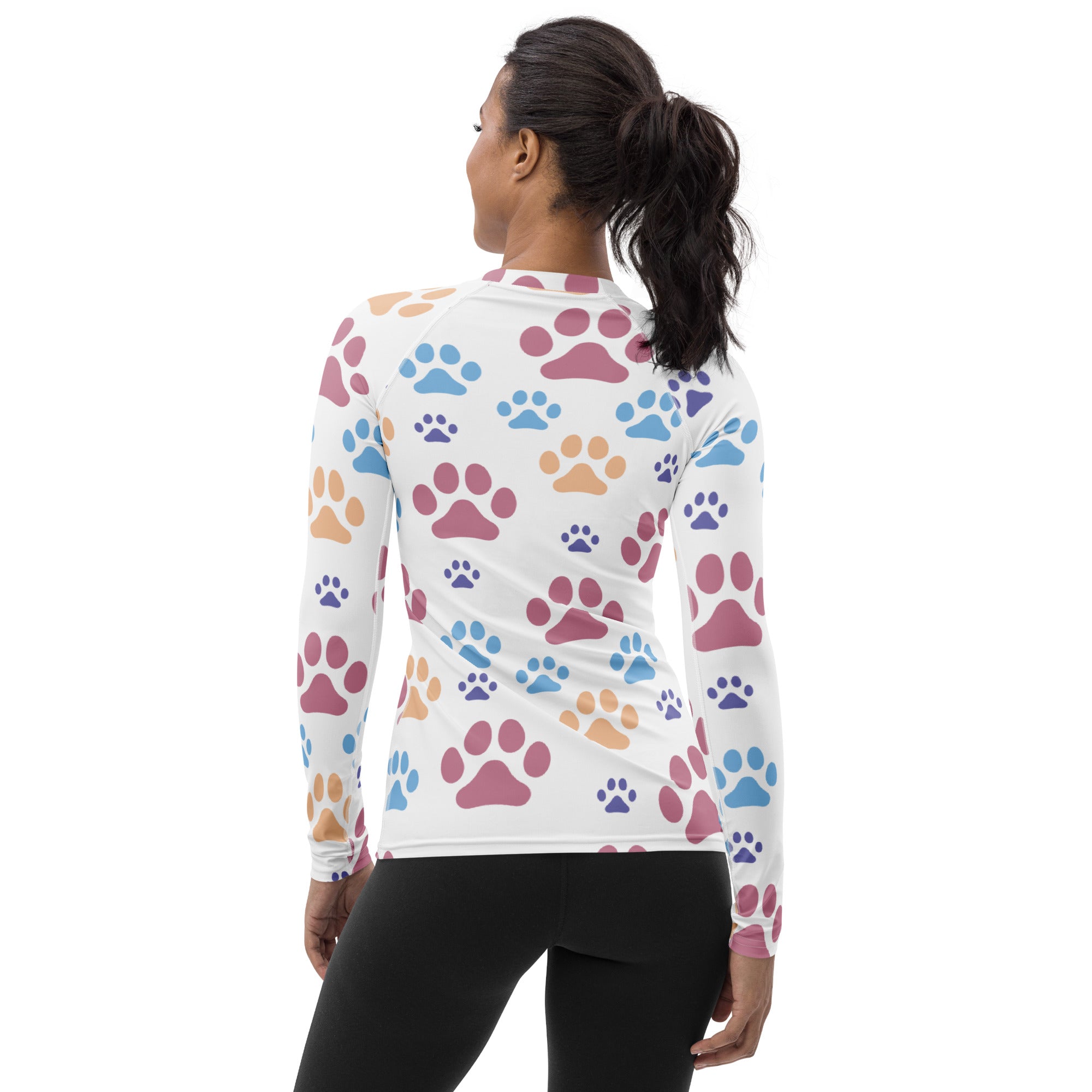 Women’s white long-sleeved buttery soft rash guard swim shirt with colorful pink blue and orange paw prints and UPF 50+